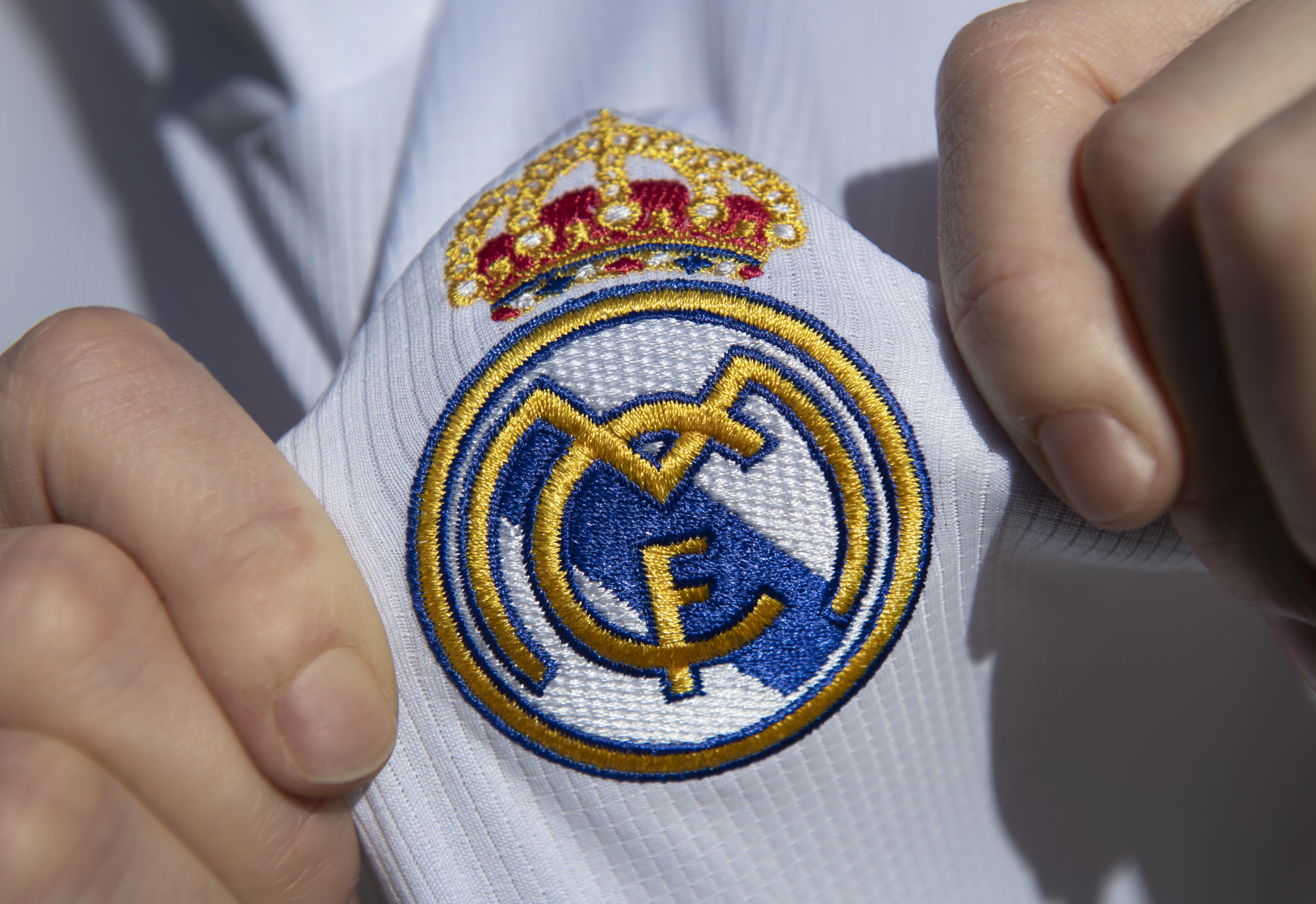 Real Madrid C.F. logo on a white shirt HD Wallpaper