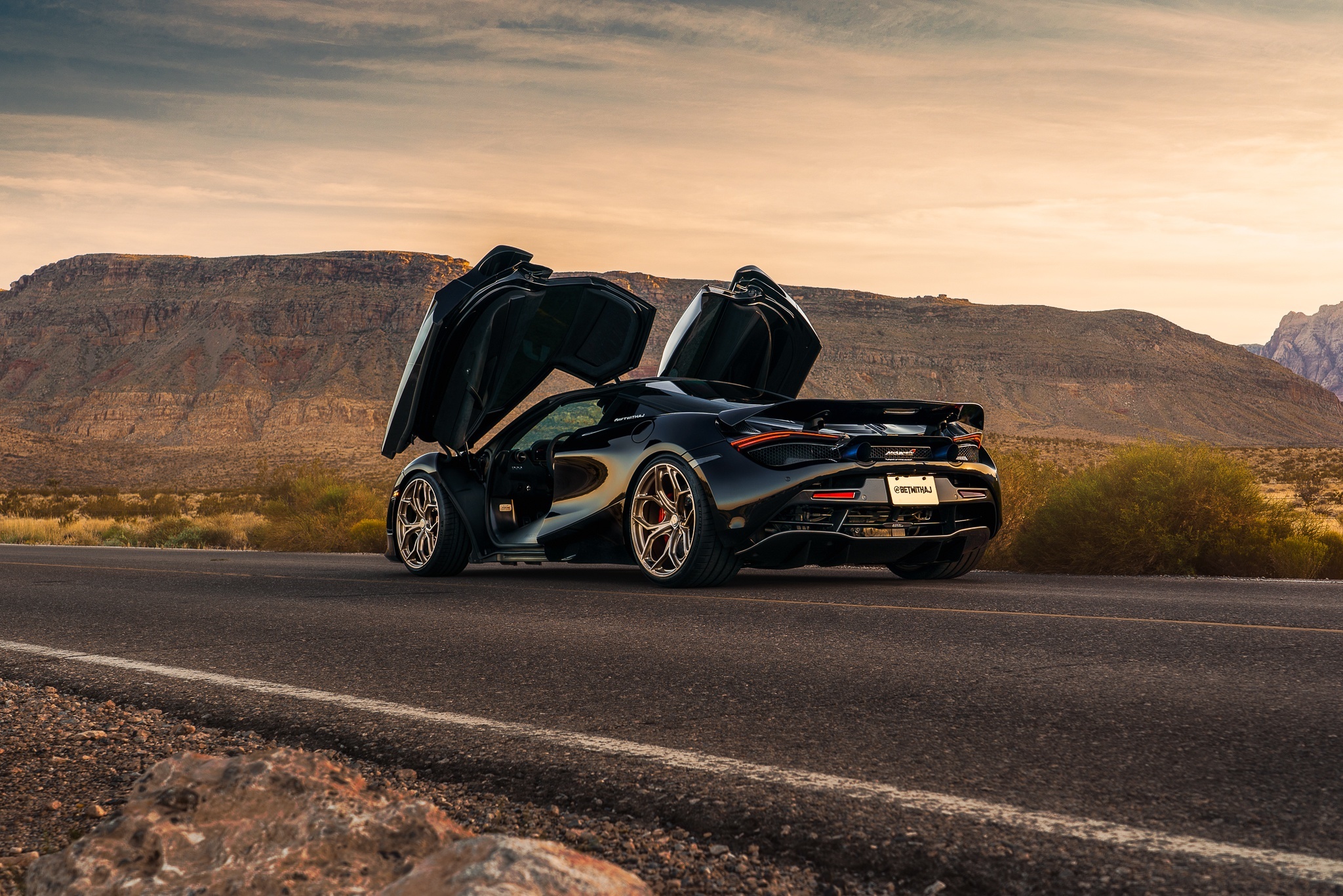 Black McLaren 720S with butterfly doors open HD Wallpaper
