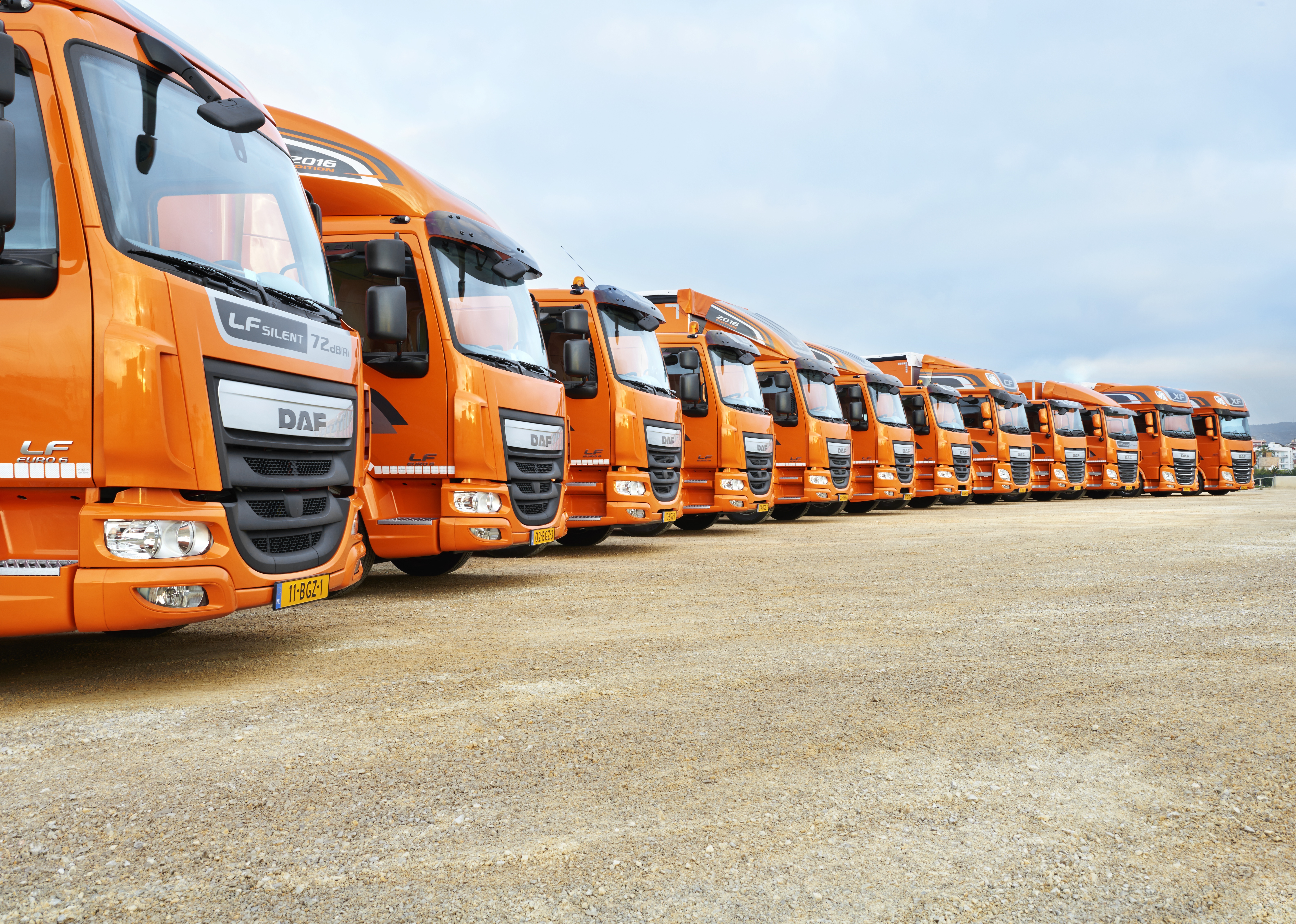 Orange DAF LF trucks parked in a lot HD Wallpaper