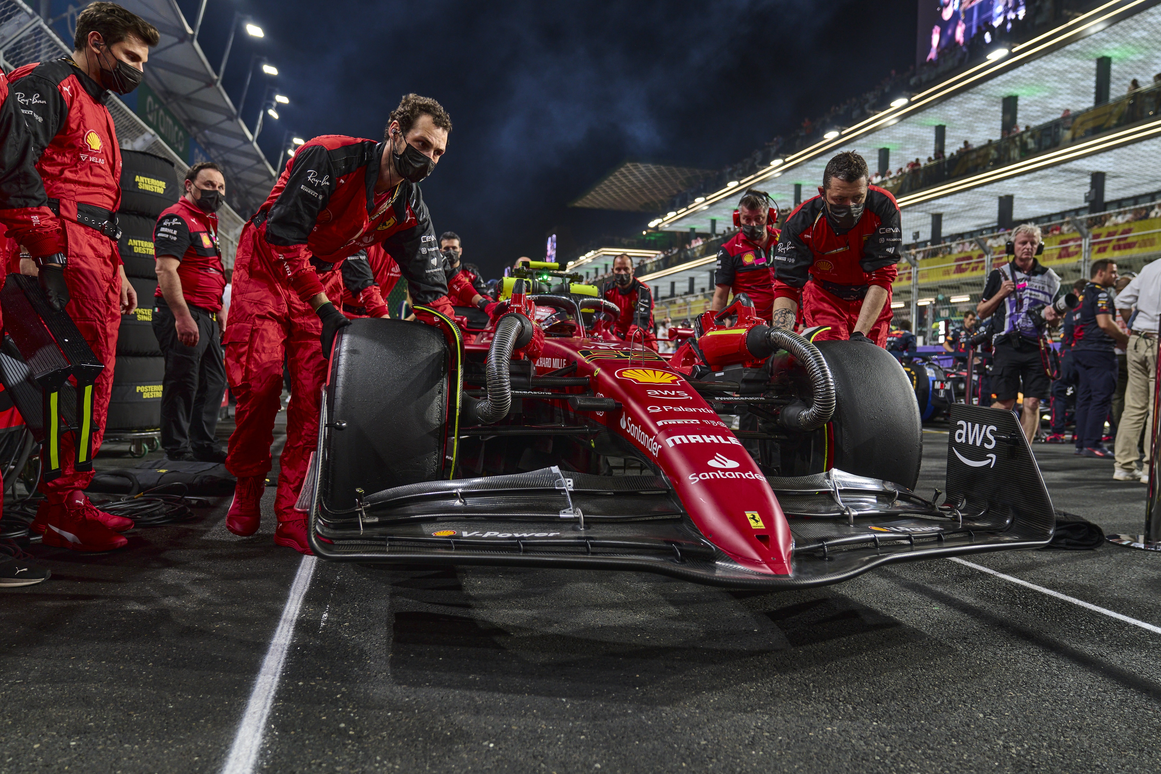 Carlos Sainz Jr. and Ferrari pit crew with Formula 1 car HD Wallpaper