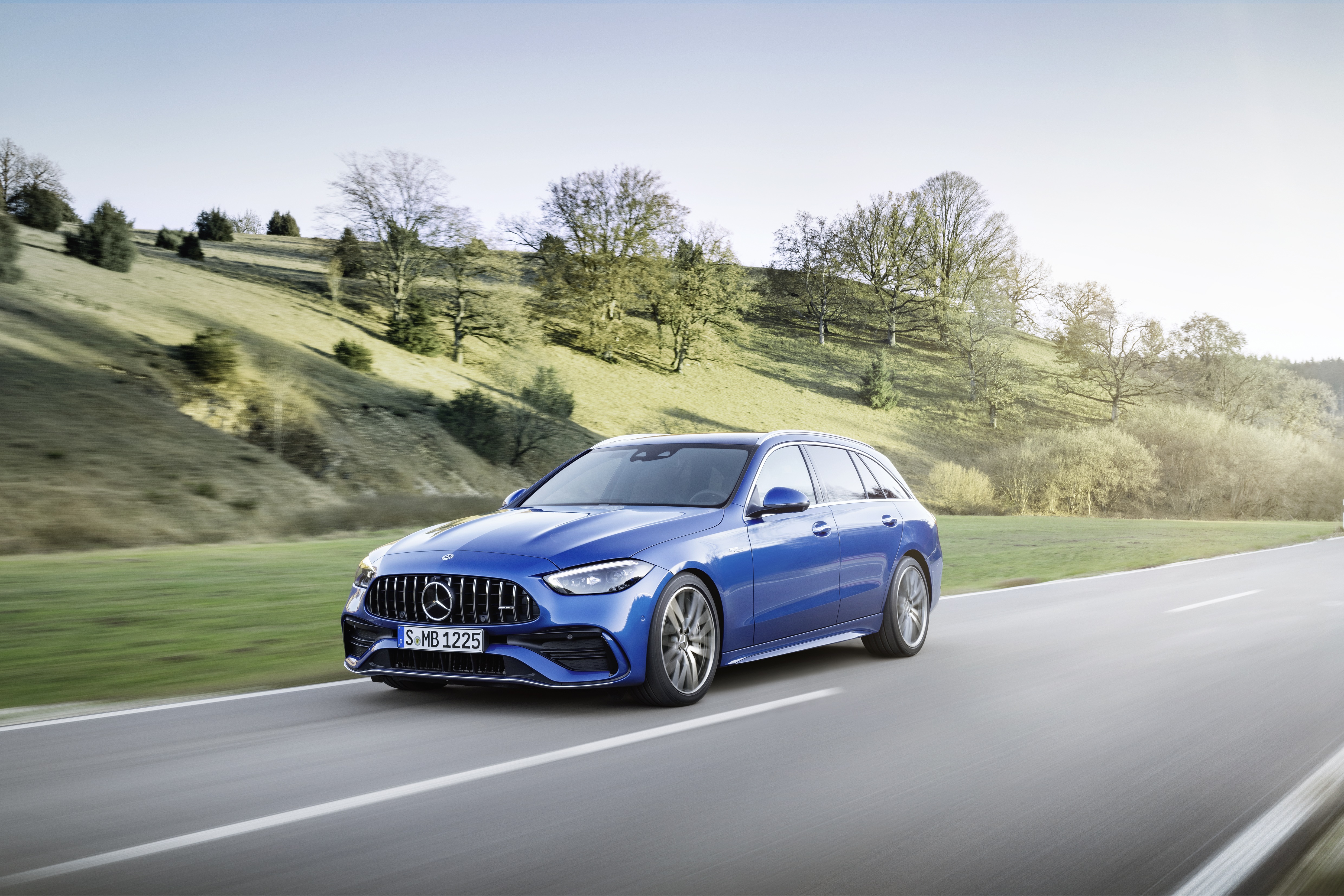 Blue Mercedes-AMG C 43 Estate driving on a road HD Wallpaper