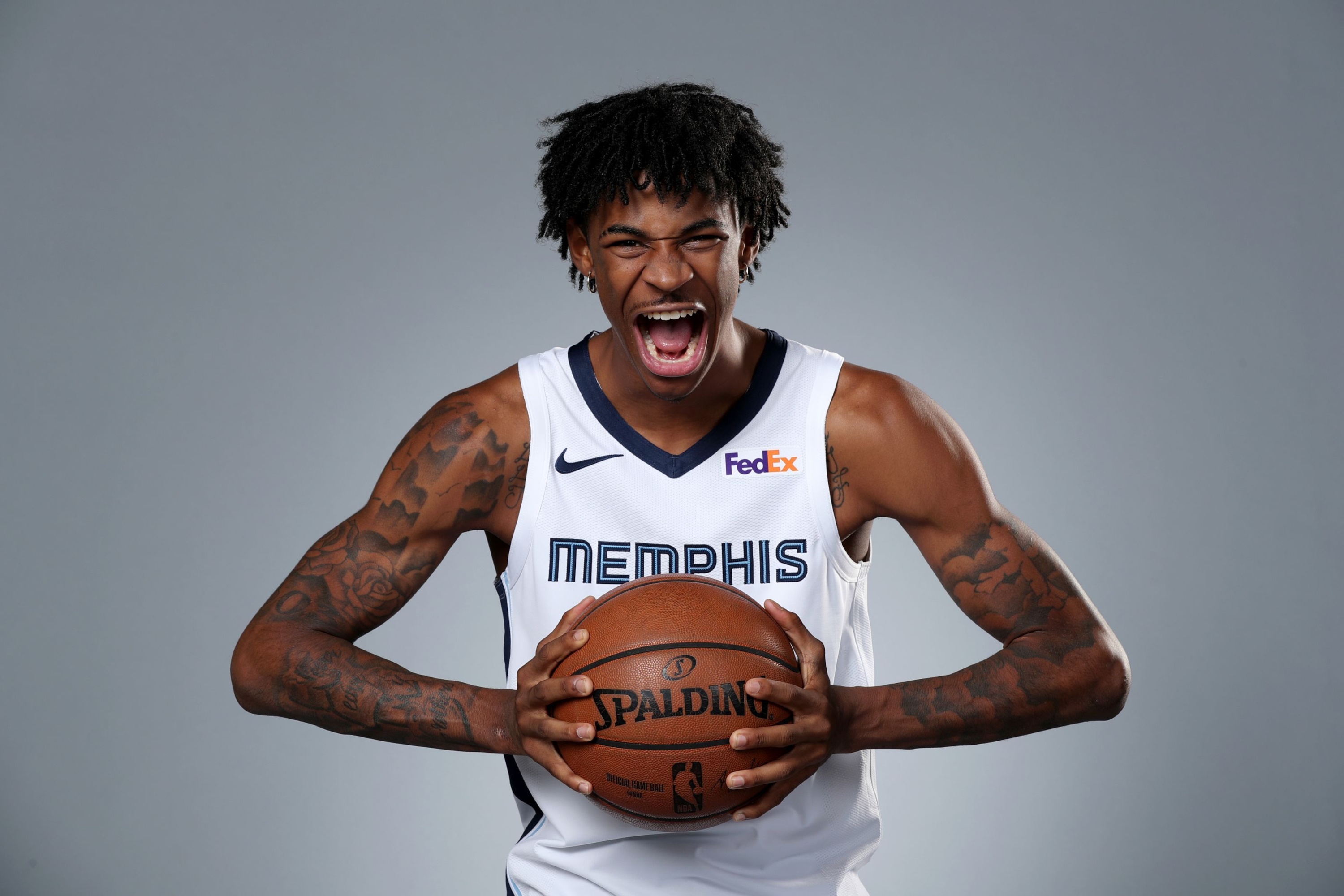 Ja Morant of the Memphis Grizzlies holding a Spalding basketball HD Wallpaper