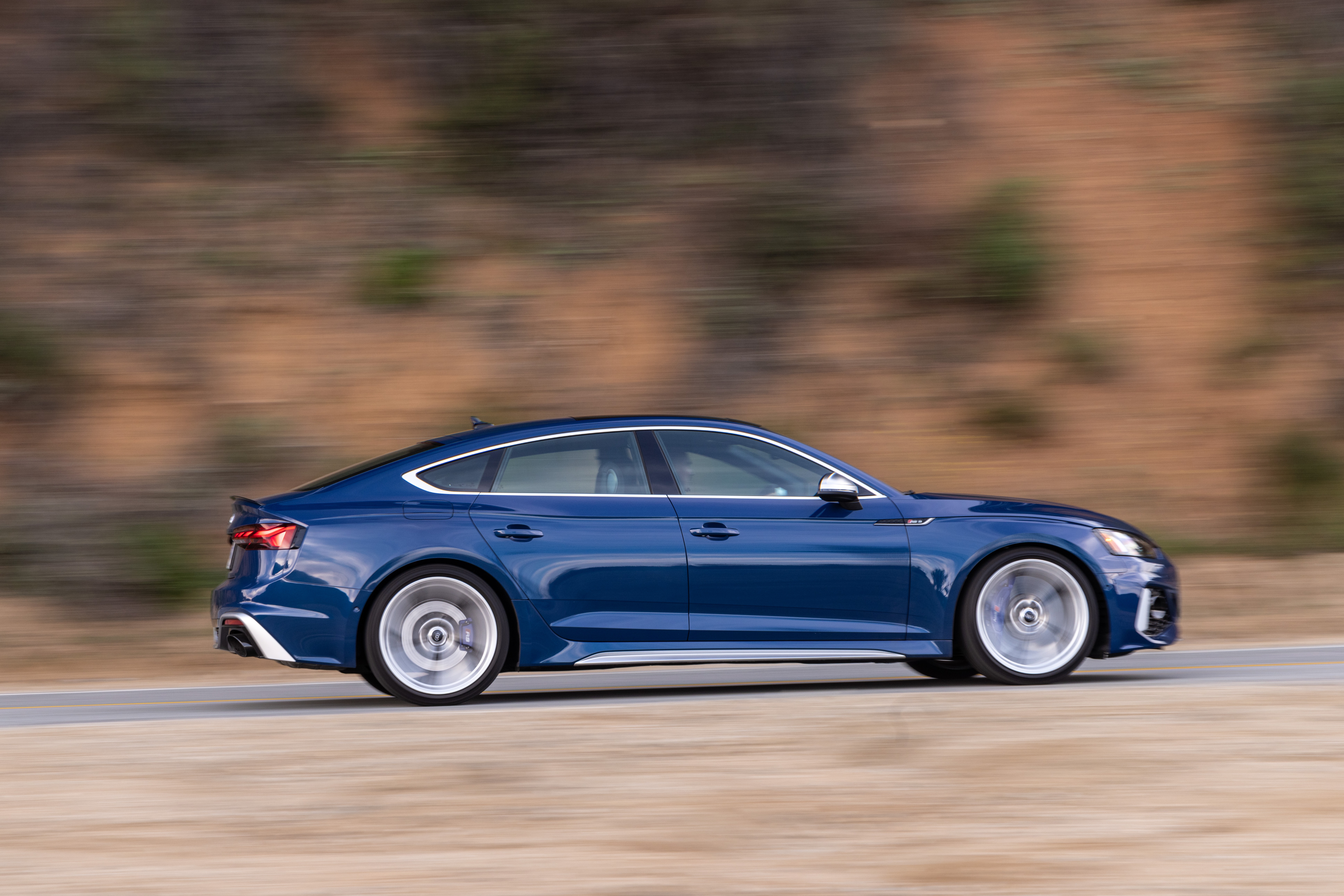 Blue Audi RS5 Sportback driving on a road HD Wallpaper