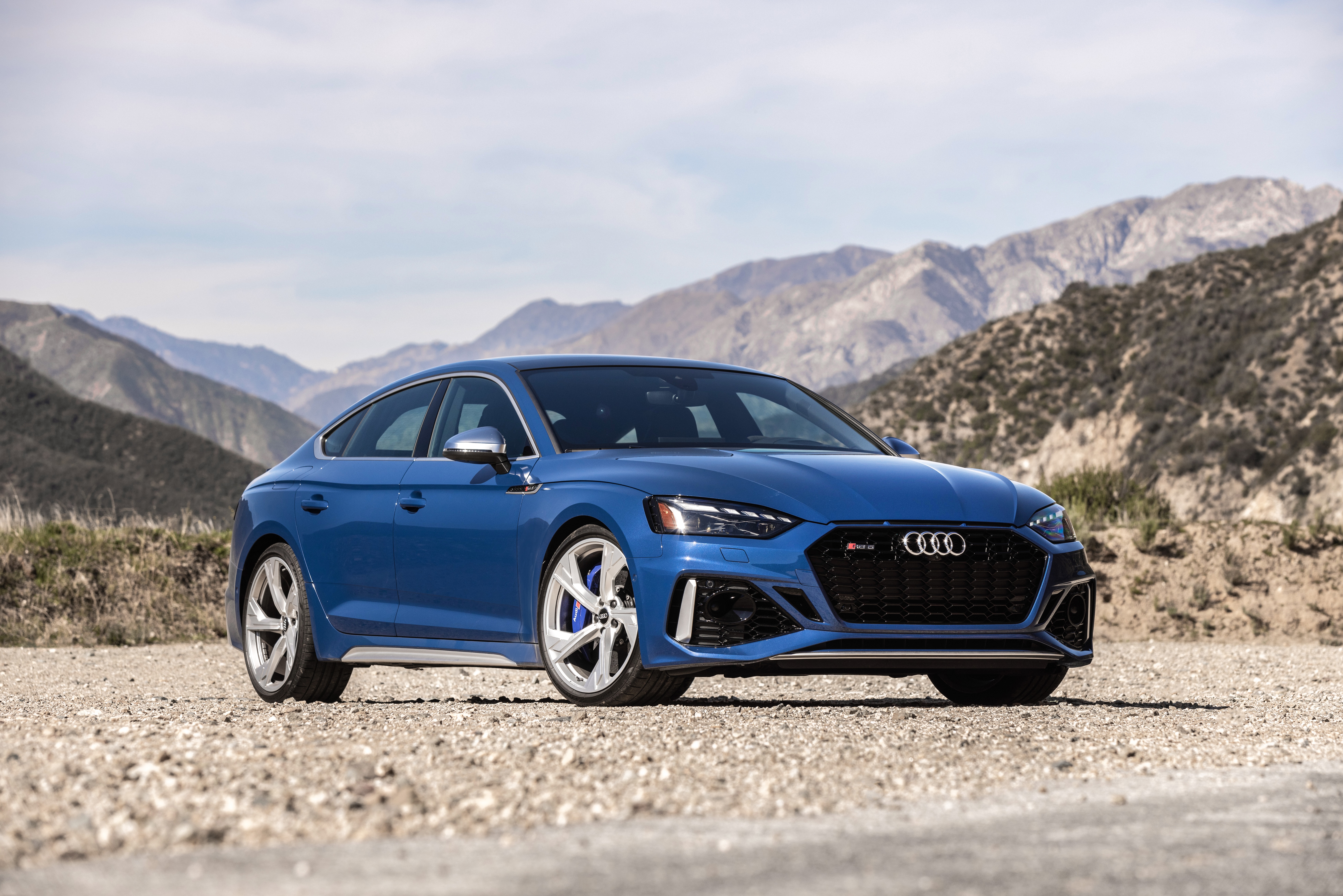 Blue Audi RS5 Sportback on a dirt road HD Wallpaper