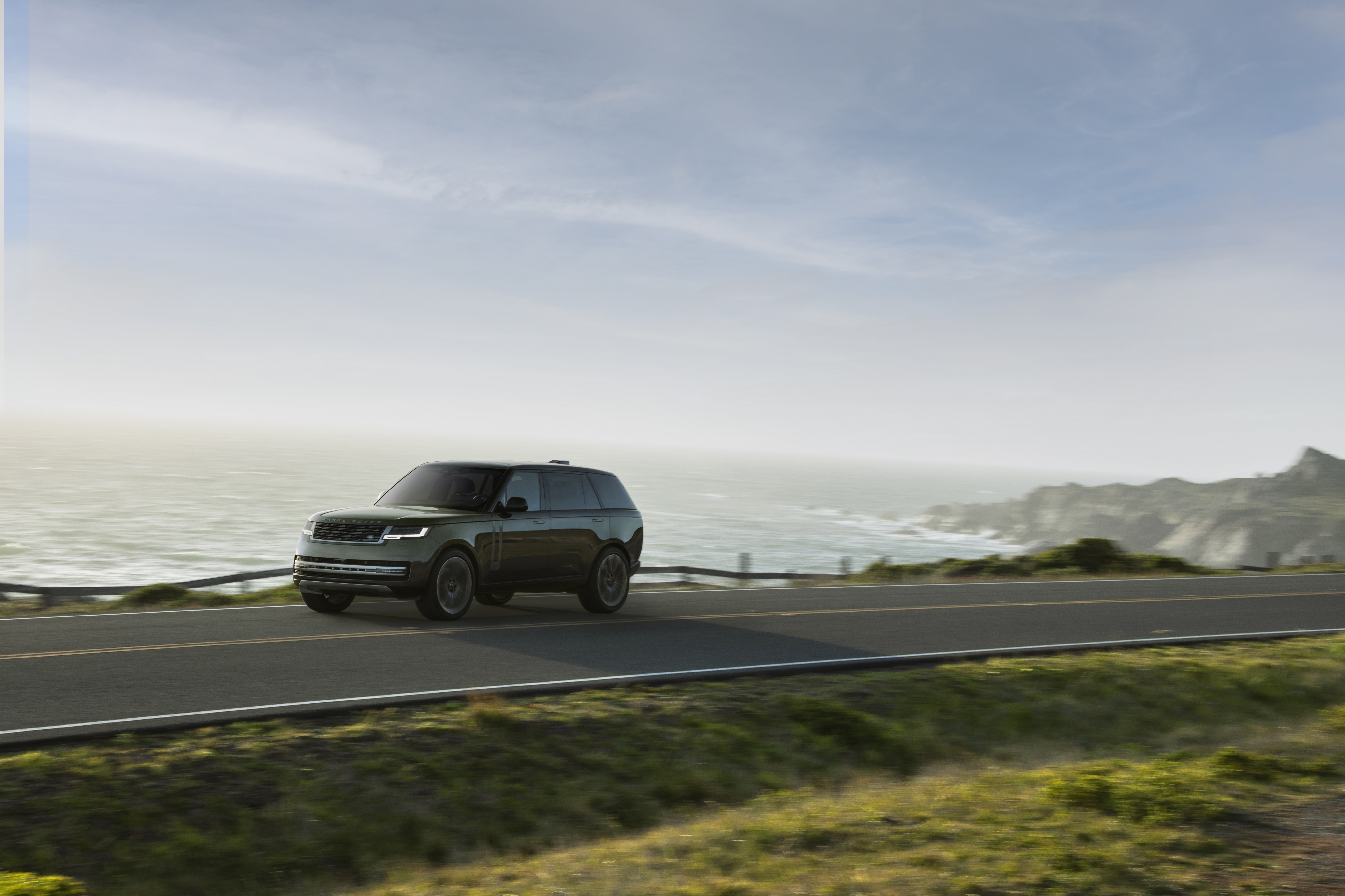 Range Rover P400 LWB 4K driving on coastal road HD Wallpaper