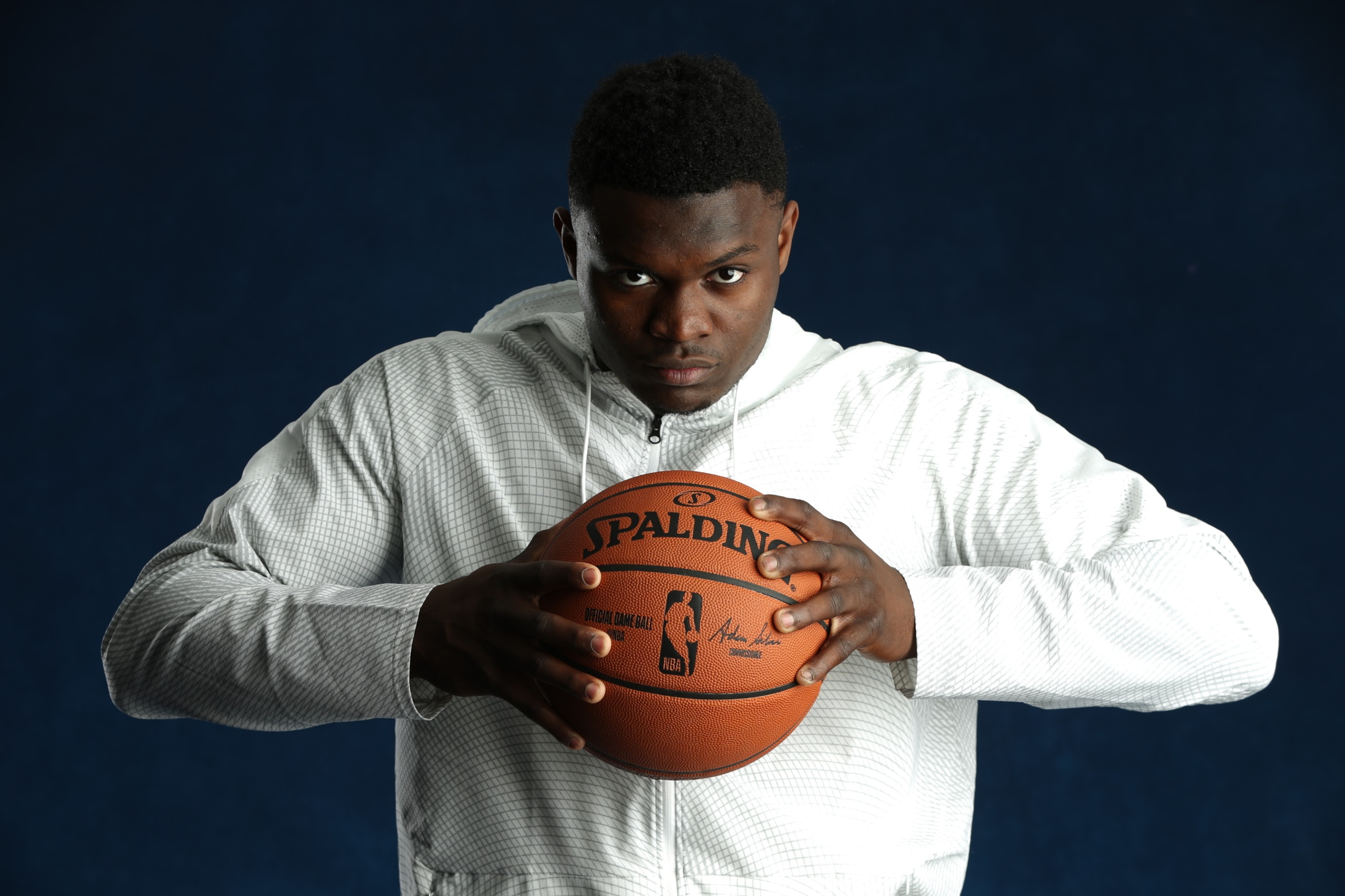 Zion Williamson holding a Spalding NBA basketball HD Wallpaper