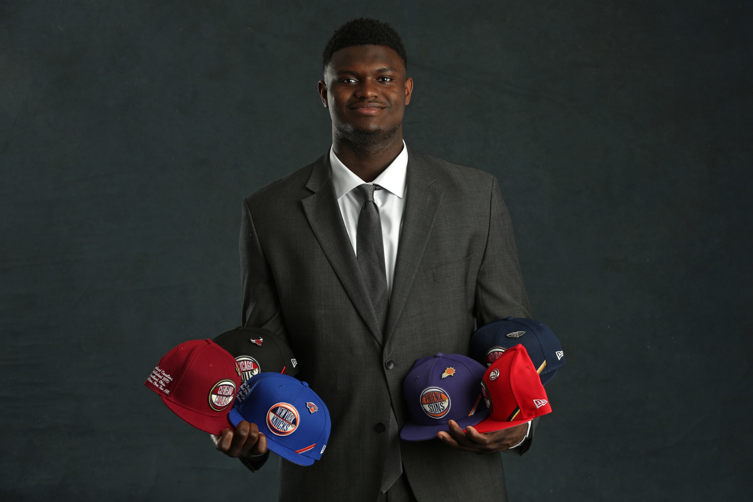 Zion Williamson holding NBA team hats HD Wallpaper