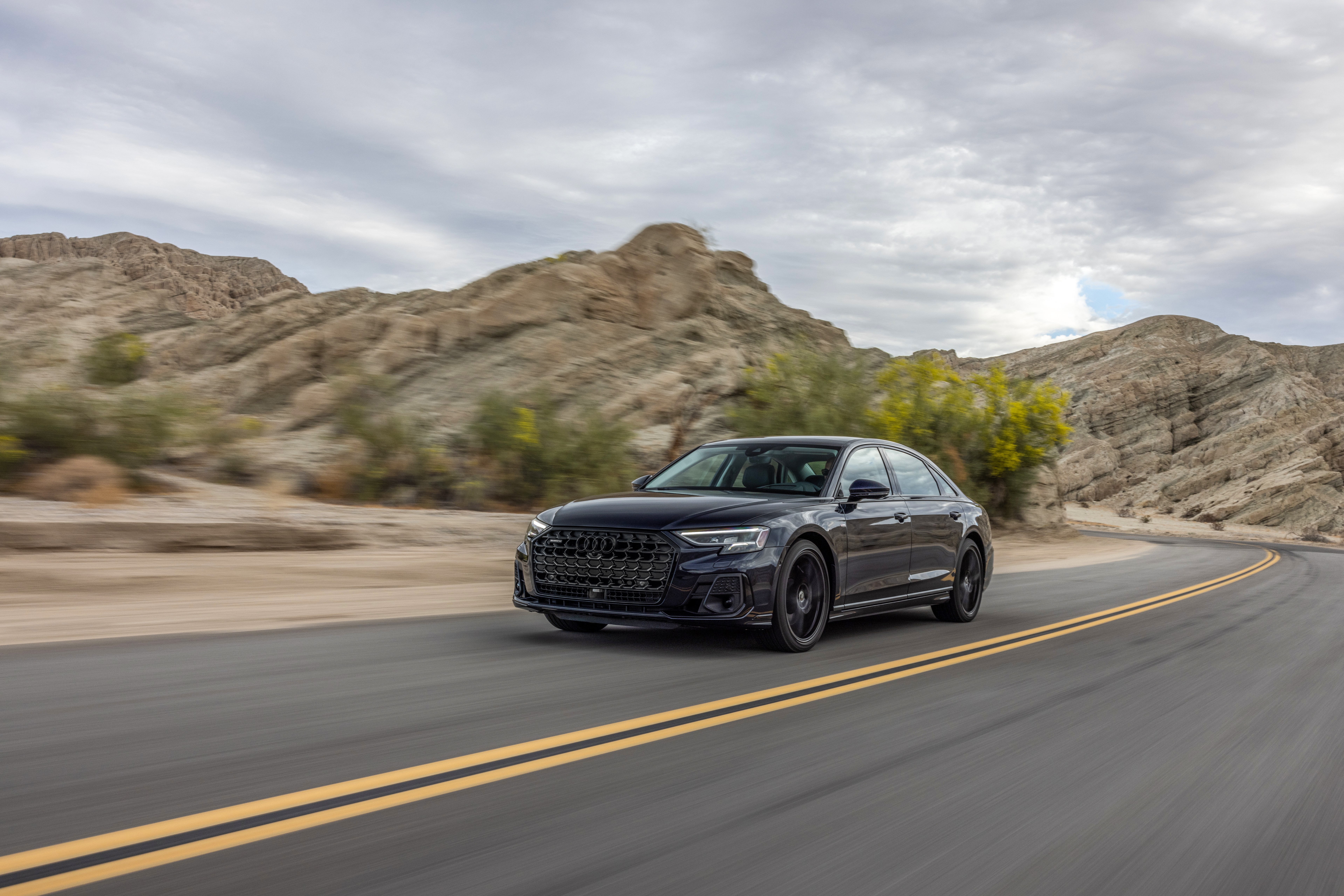 Black Audi A8 driving on a desert road HD Wallpaper