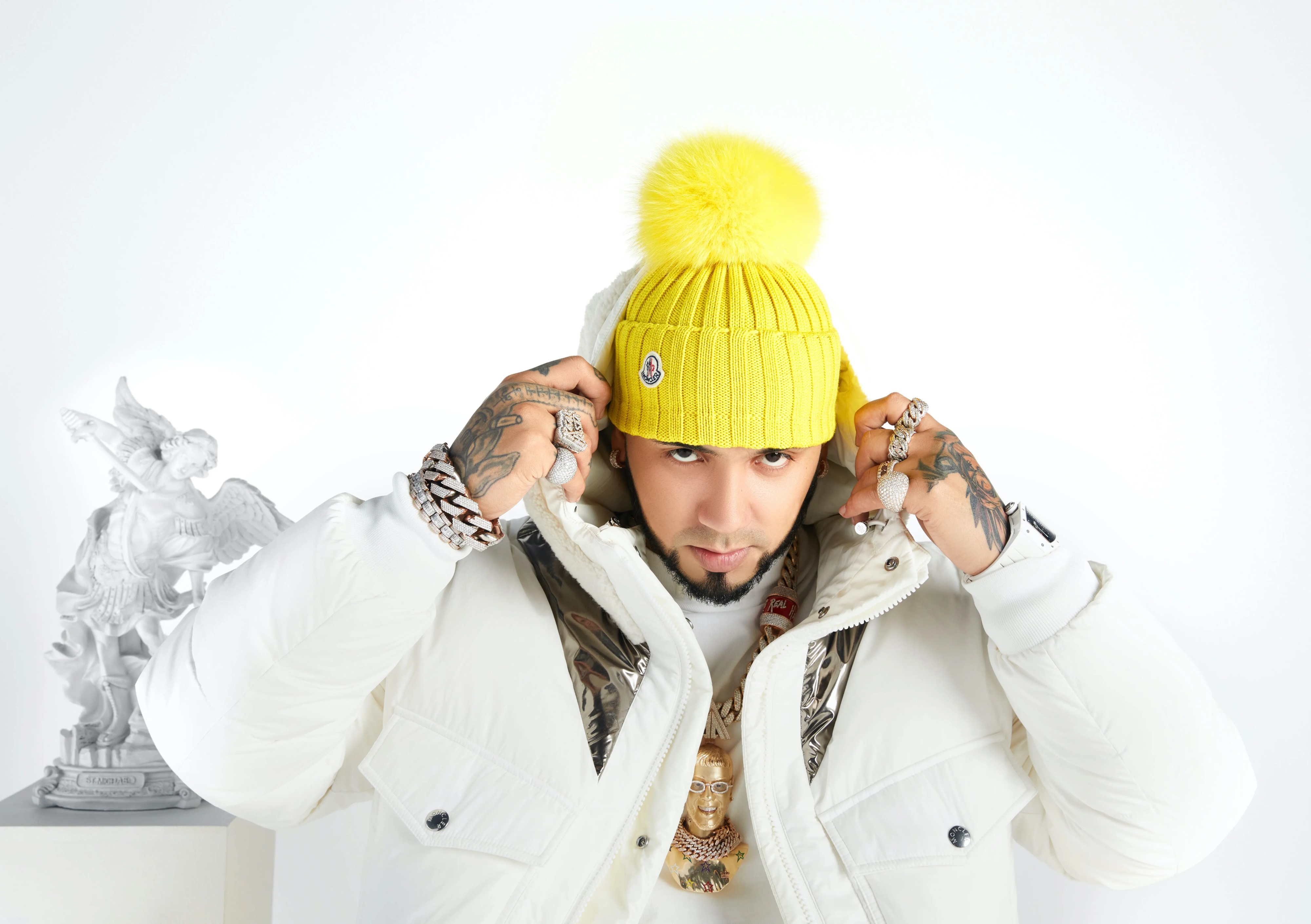 Anuel AA in yellow beanie and white jacket 4K HD Wallpaper
