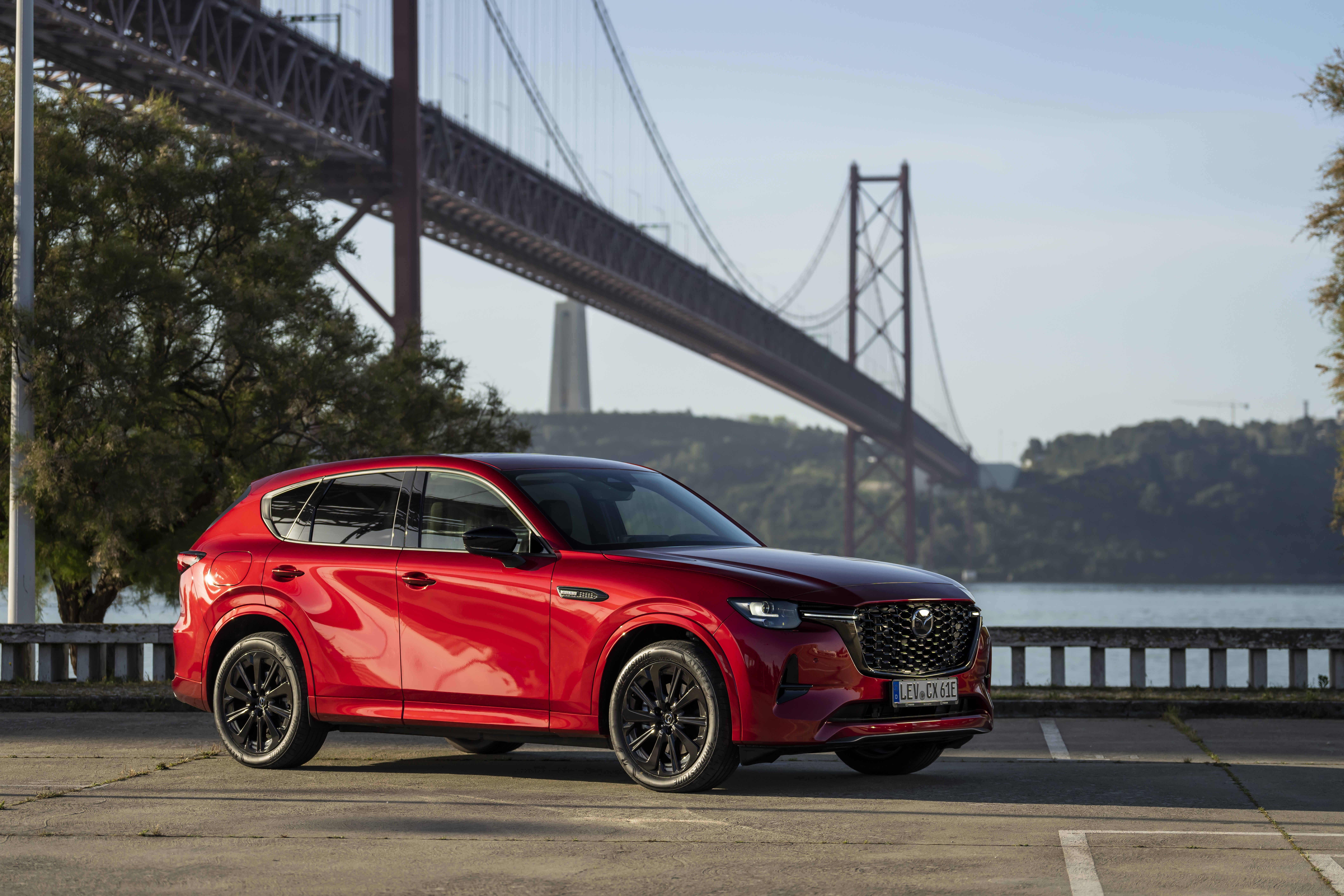 Red Mazda CX-60 parked near a bridge HD Wallpaper