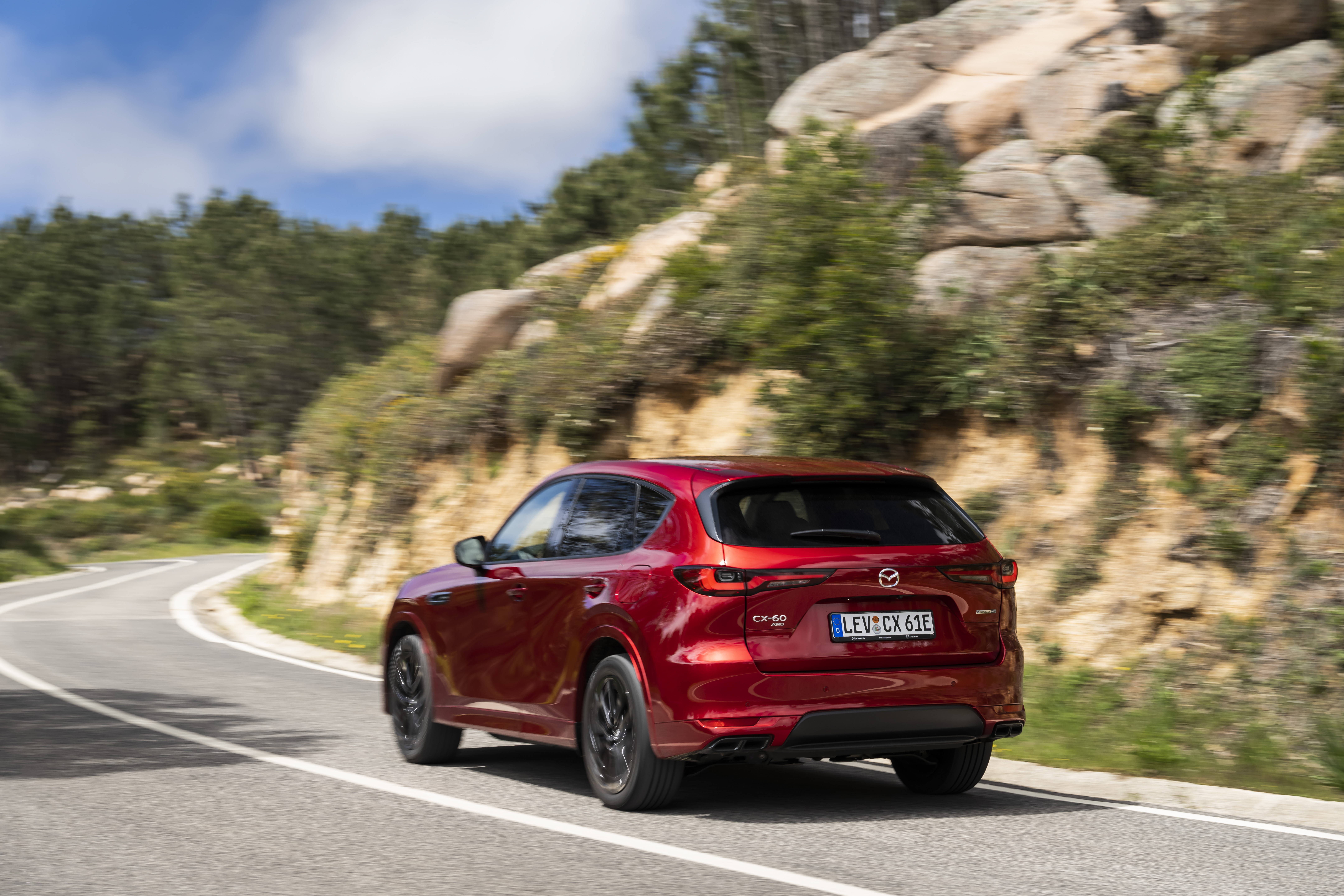 Red Mazda CX-60 driving on a winding road HD Wallpaper