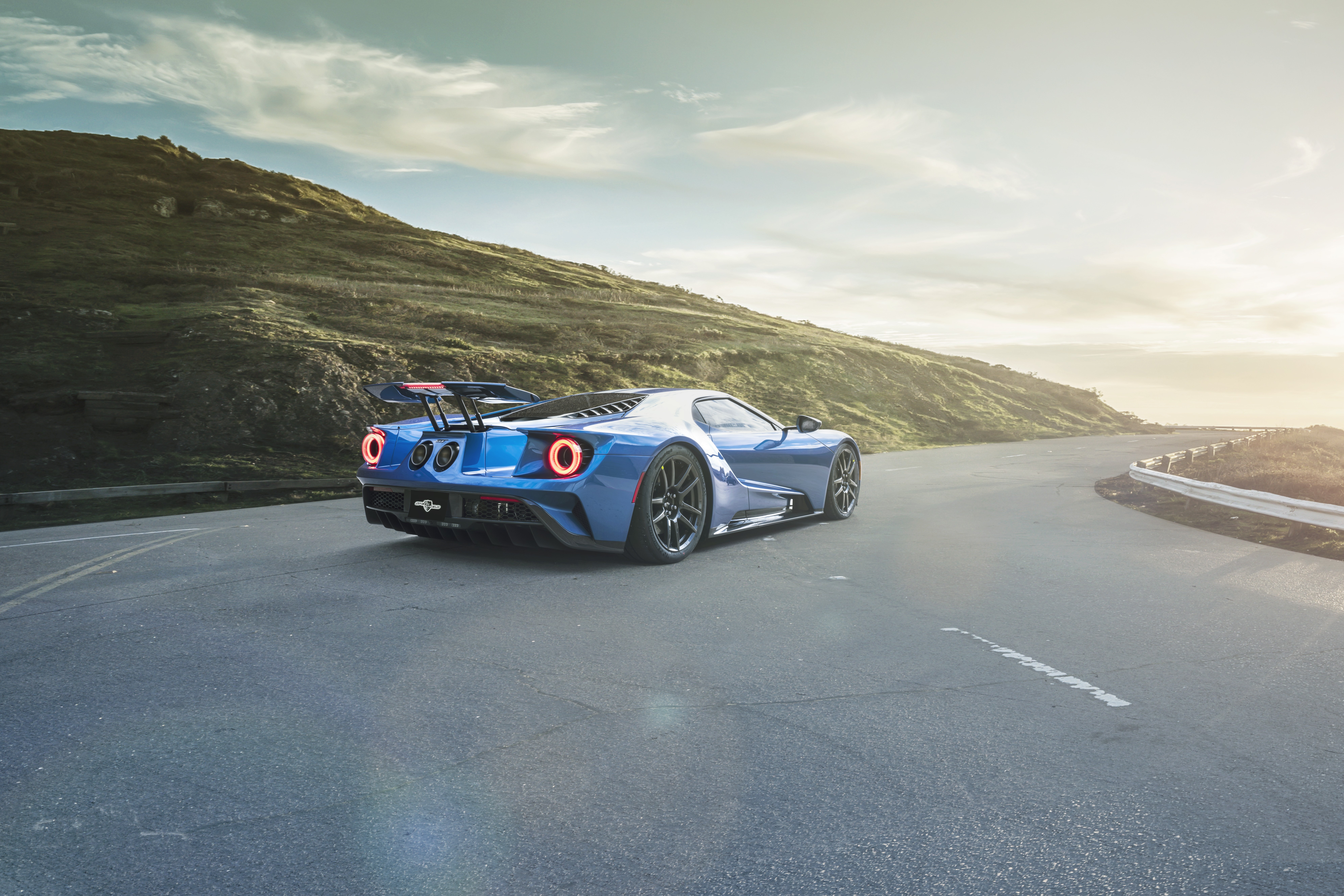 Blue Ford GT driving on a coastal road HD Wallpaper