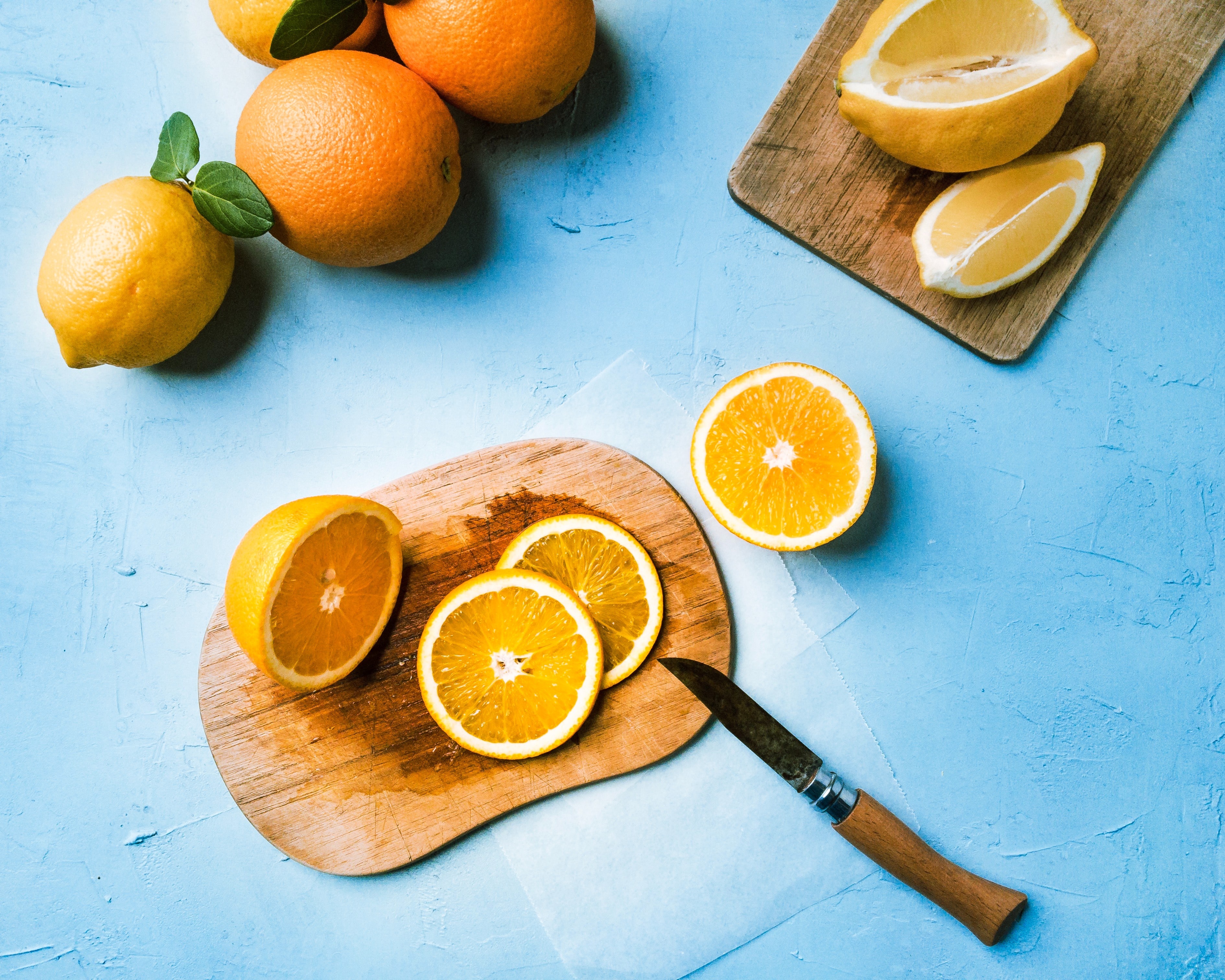 Oranges and lemons on a blue surface HD Wallpaper