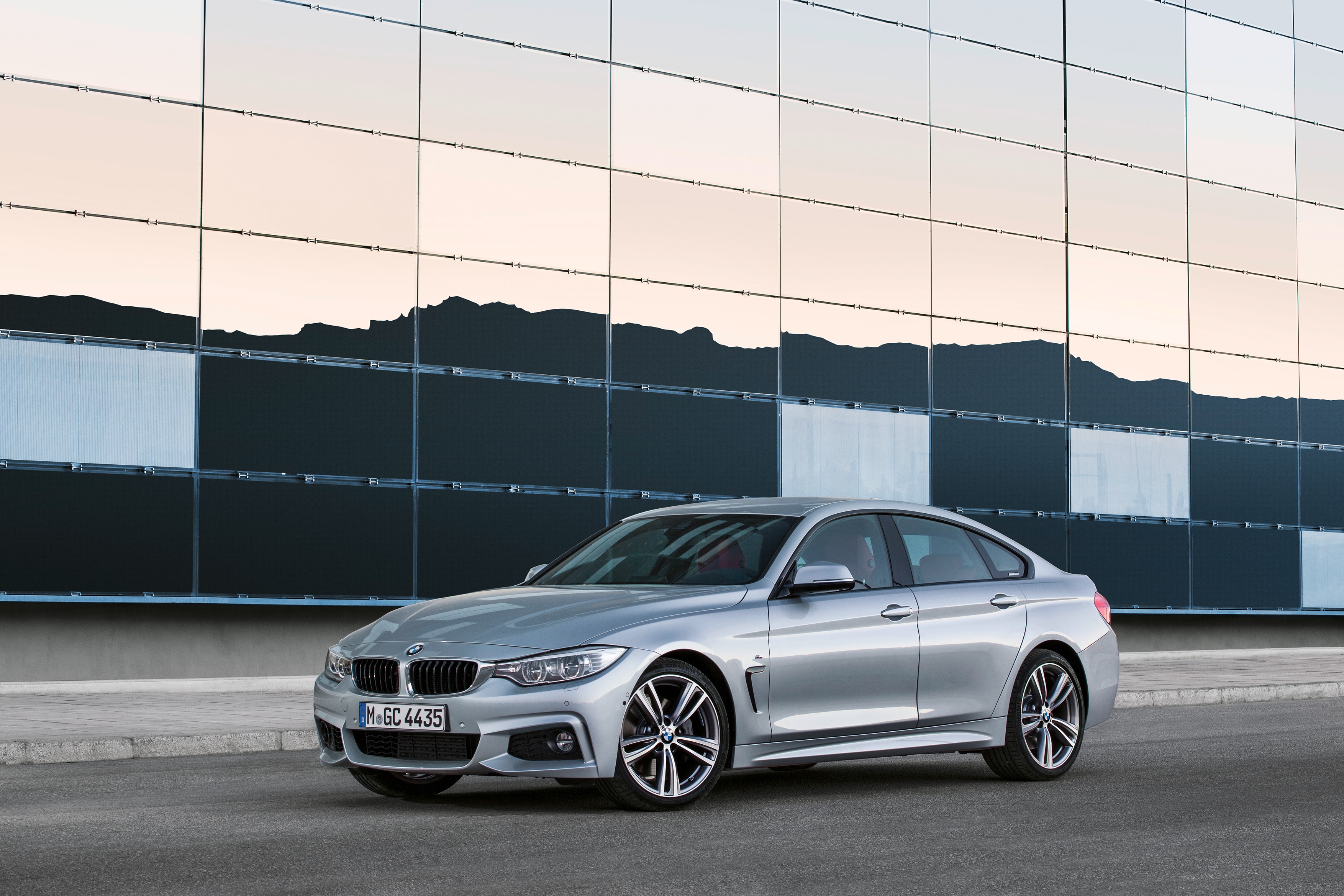 Silver BMW 4 Series Gran Coupé parked in front of a modern building HD Wallpaper