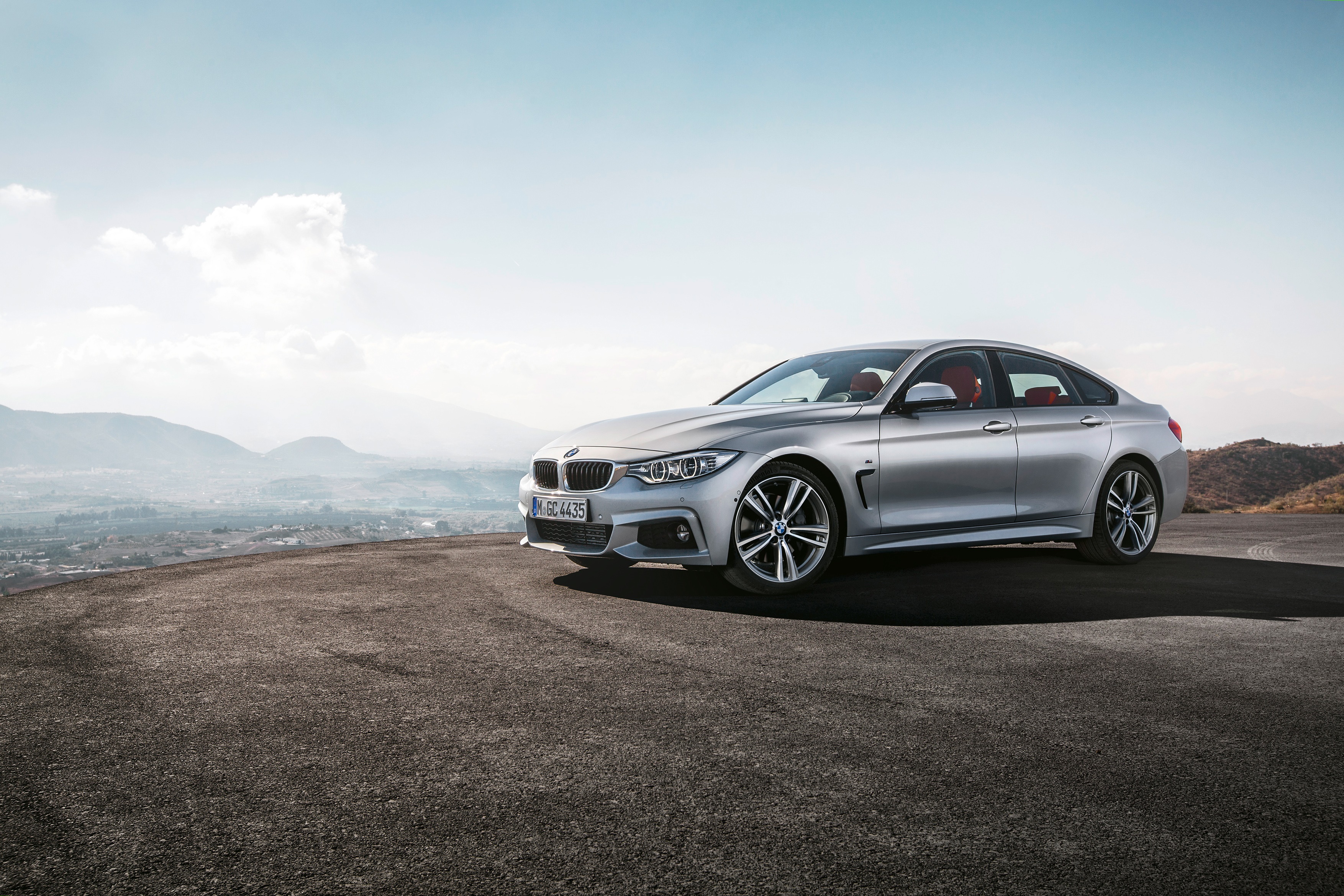 Silver BMW 4 Series Gran Coupé on a scenic overlook HD Wallpaper
