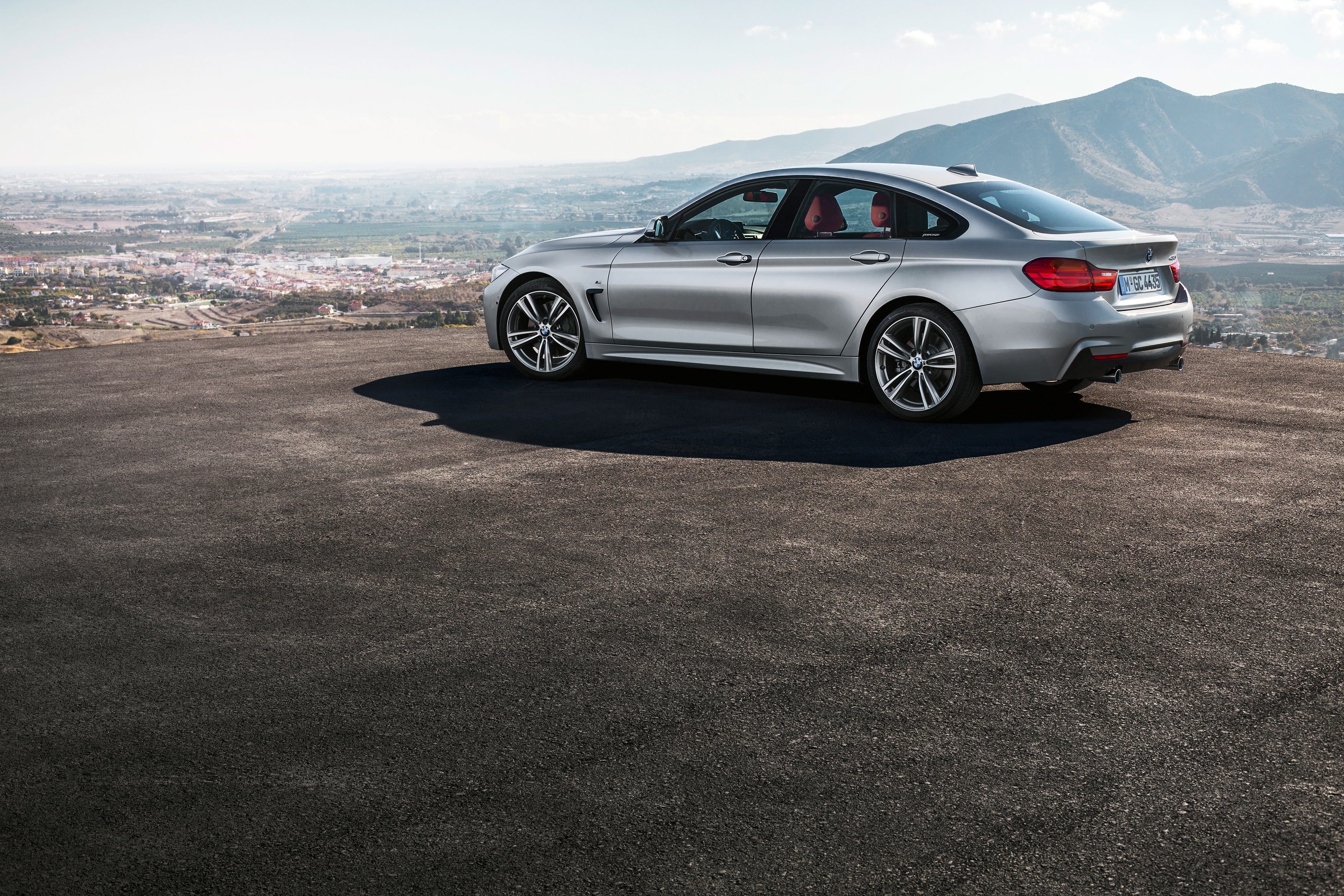 Silver BMW 4 Series Gran Coupé on a scenic overlook HD Wallpaper