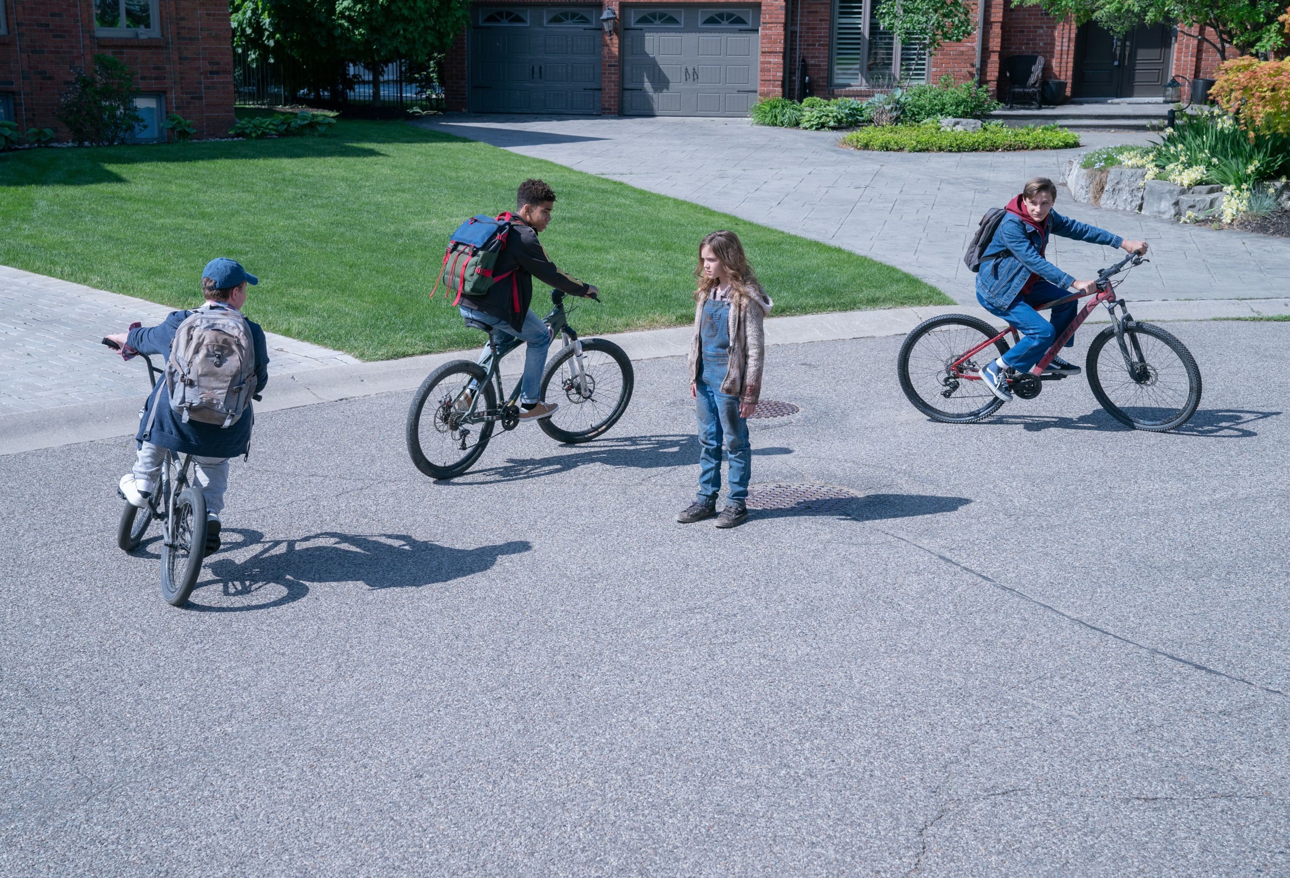 Children on bicycles in a suburban street HD Wallpaper