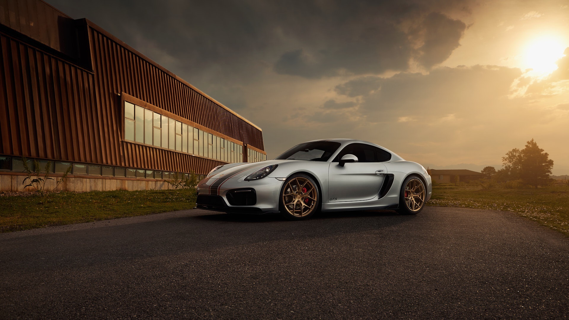 Silver Porsche Cayman GTS parked outside building HD Wallpaper