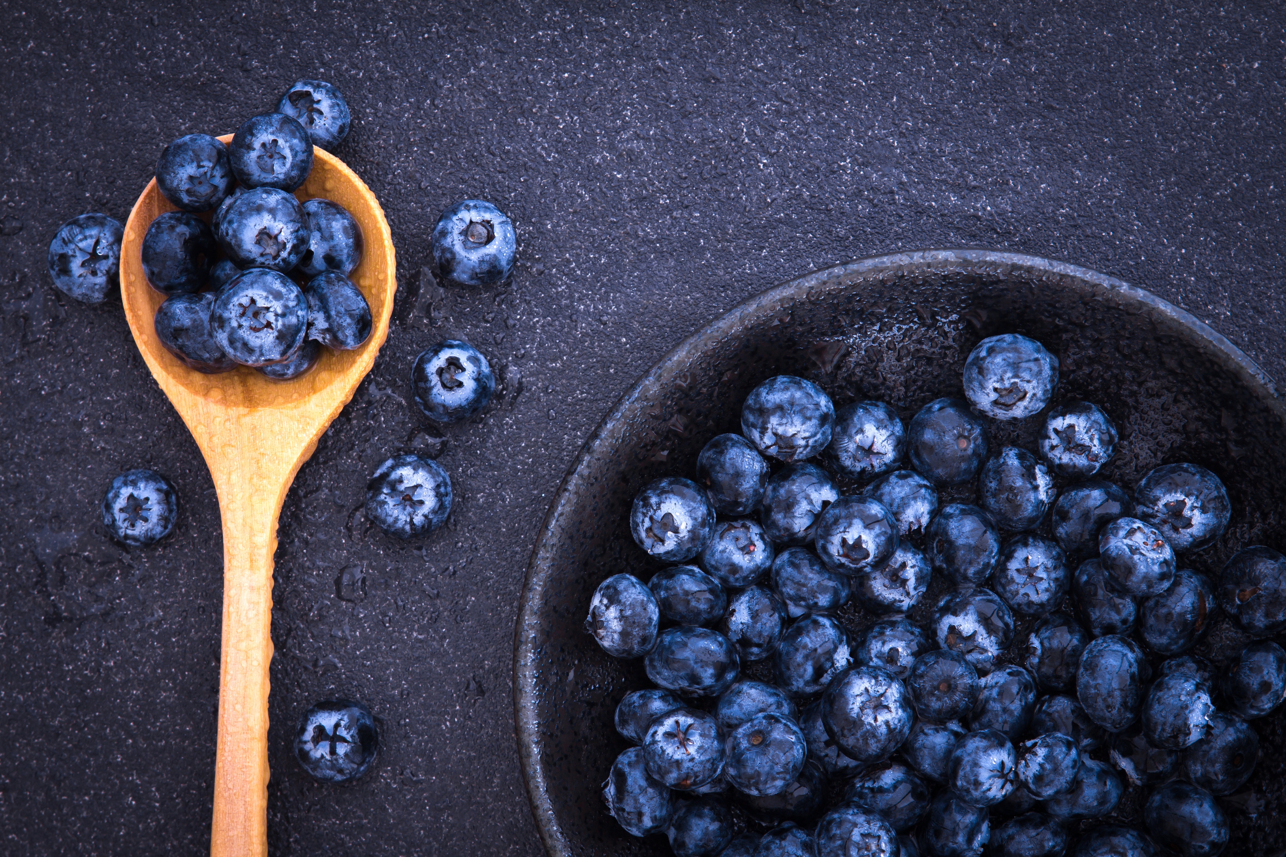 Blueberries in a wooden spoon and bowl 4K HD Wallpaper