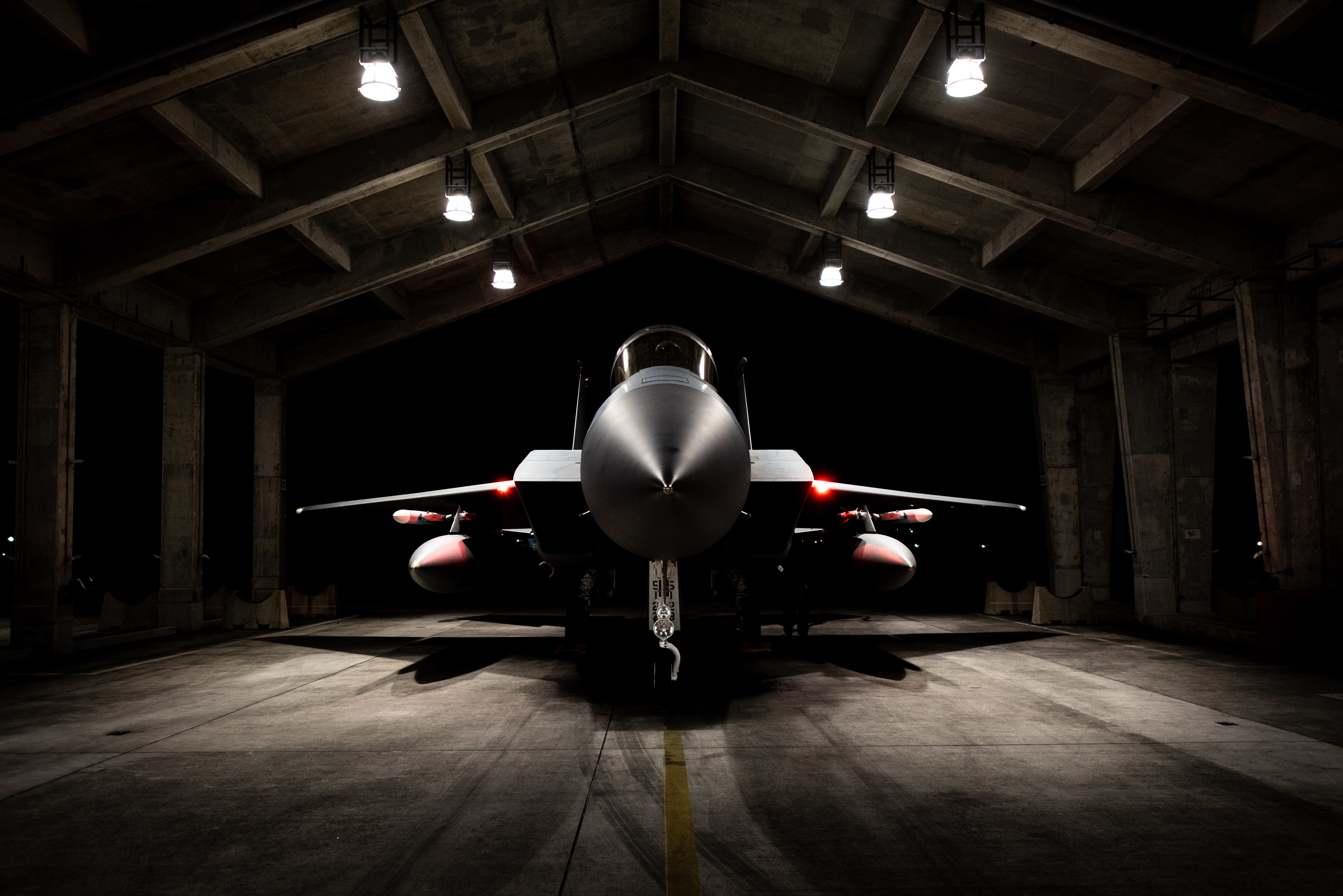 F-15 fighter jet in a hangar HD Wallpaper