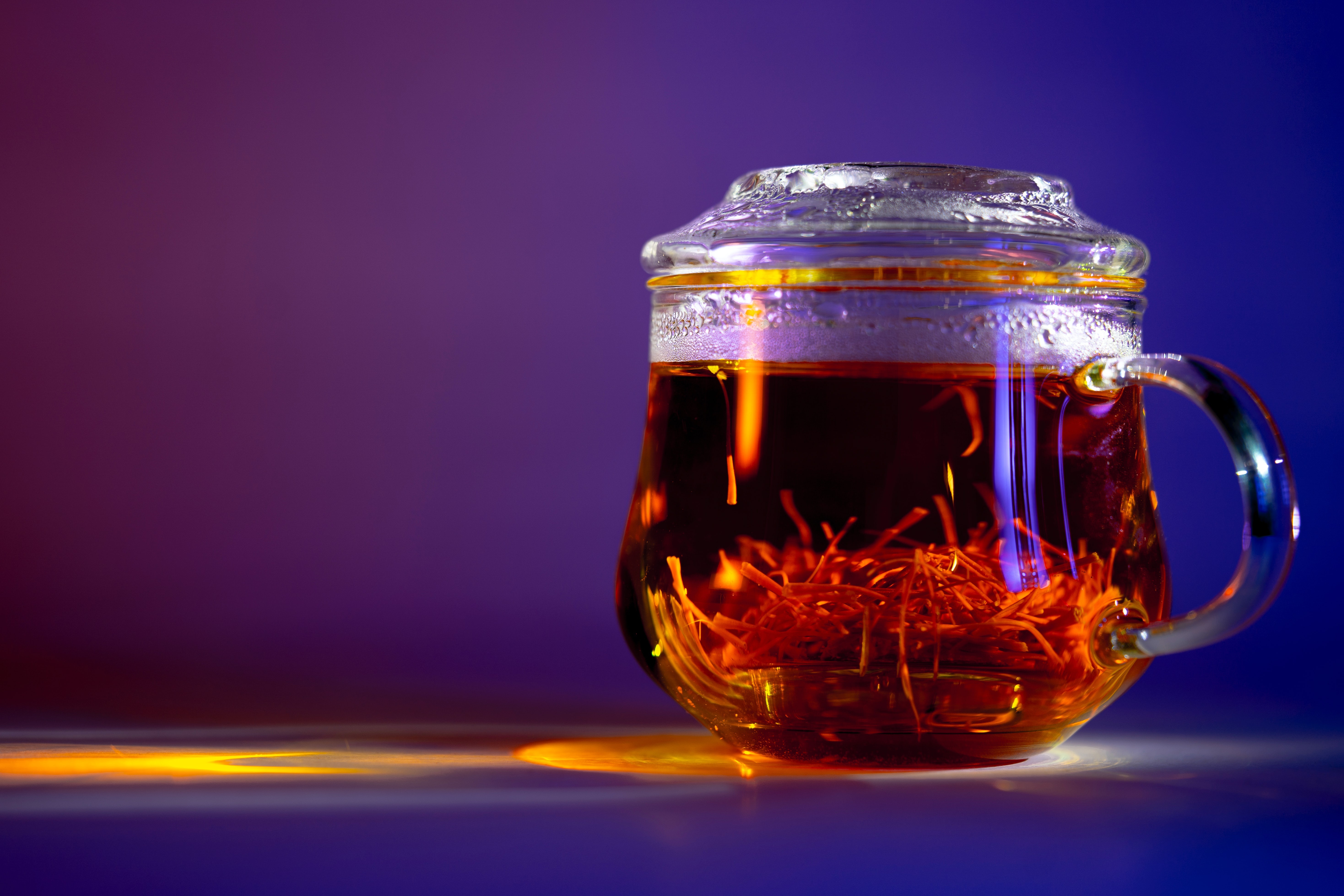 Tea in a glass mug with saffron HD Wallpaper