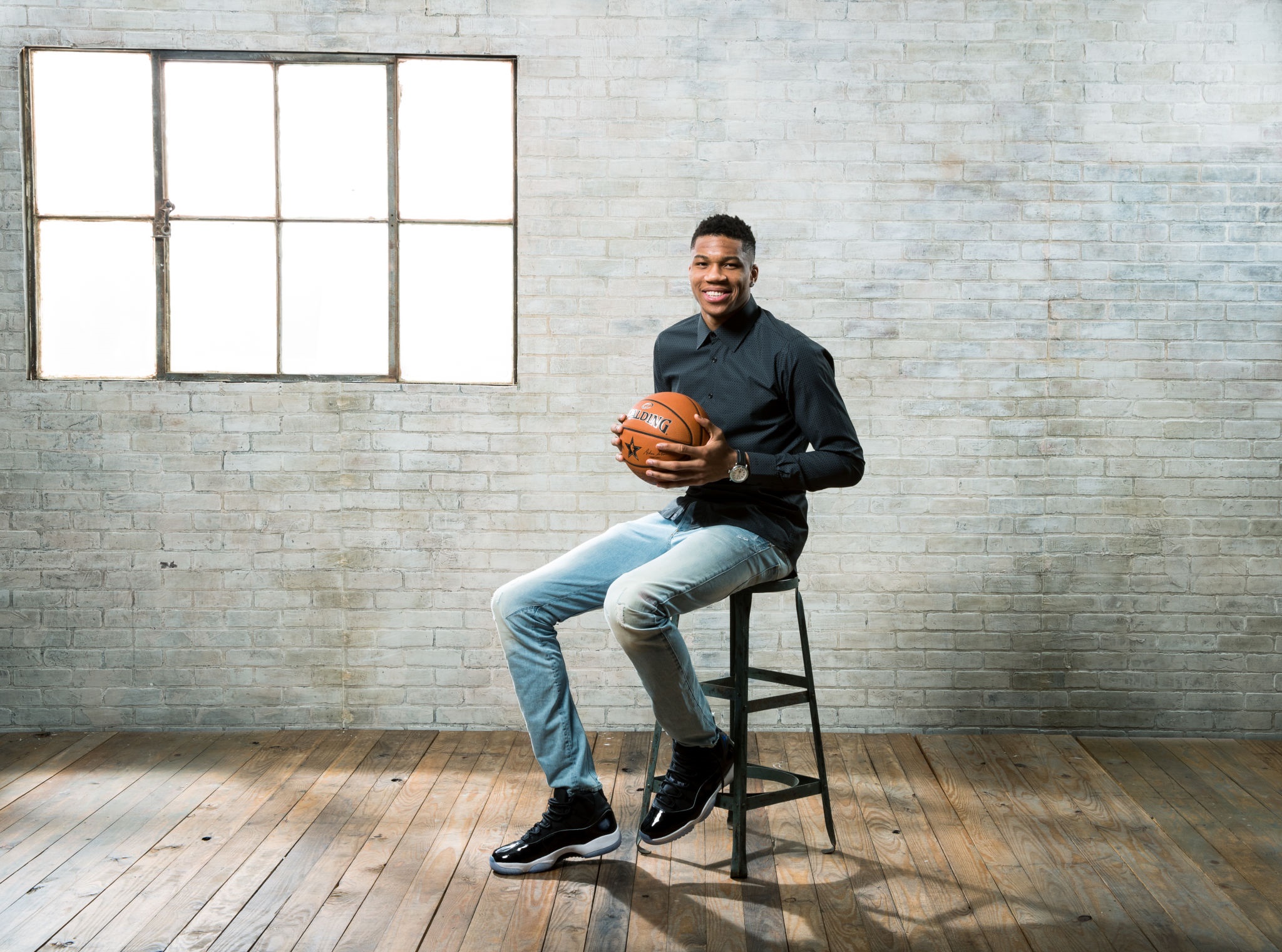 Giannis Antetokounmpo holding a basketball HD Wallpaper
