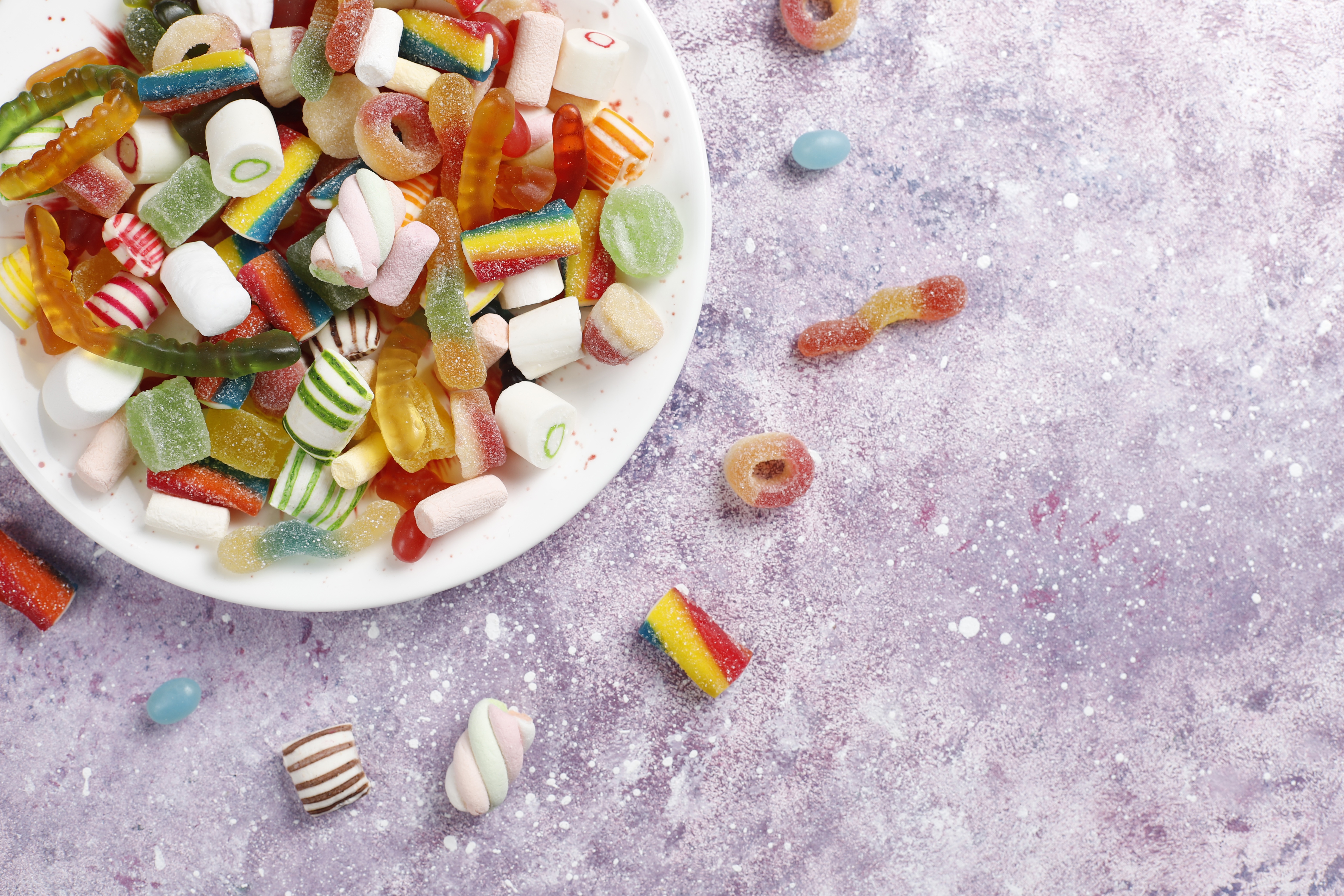 Assortment of colorful candies in a white bowl, 4K HD Wallpaper