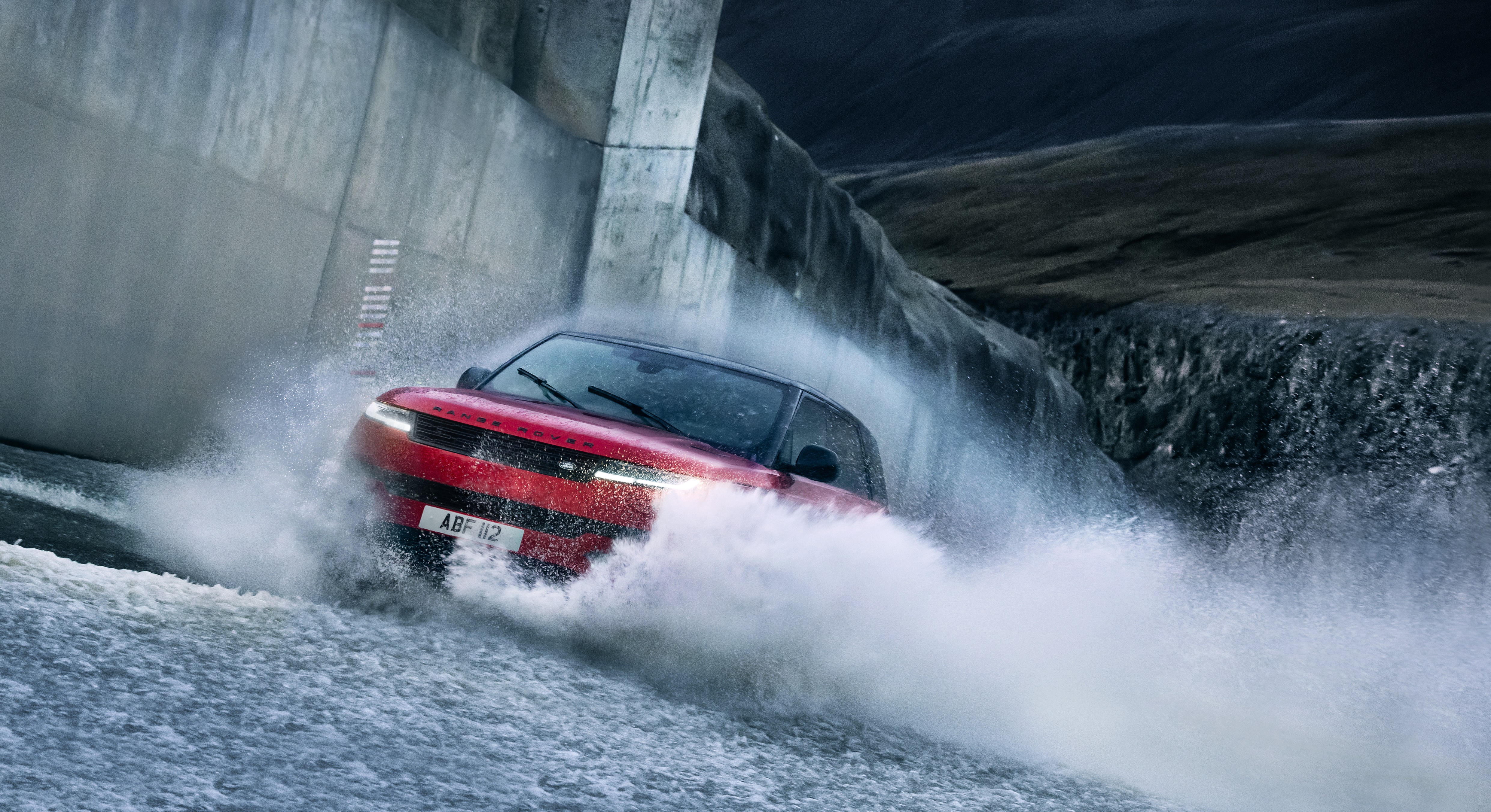 Red Range Rover Sport PHEV driving through water HD Wallpaper