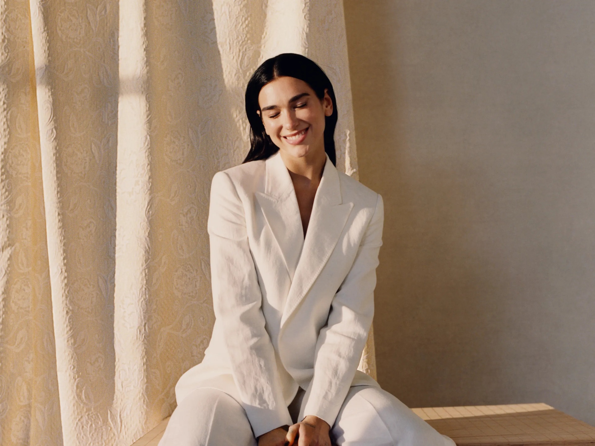 Dua Lipa in a white suit HD Wallpaper