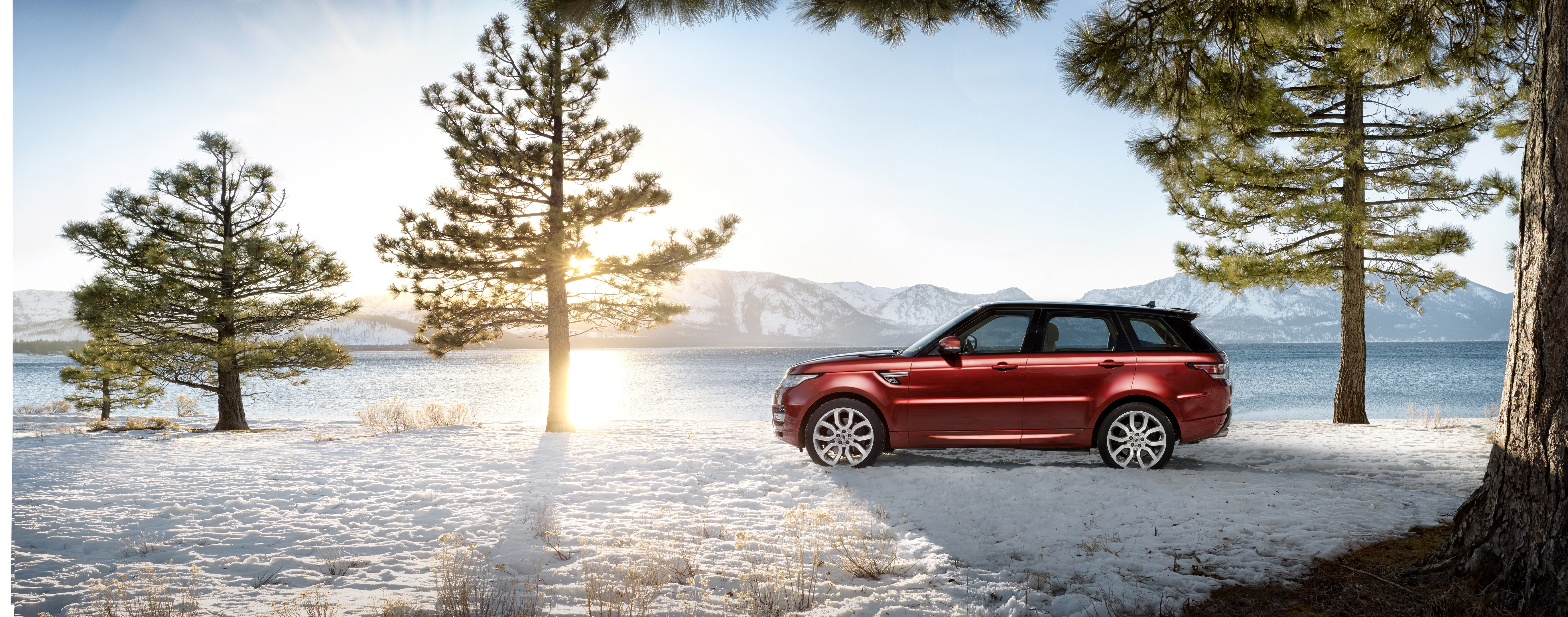 Red Range Rover Sport 4K by a snowy lake HD Wallpaper