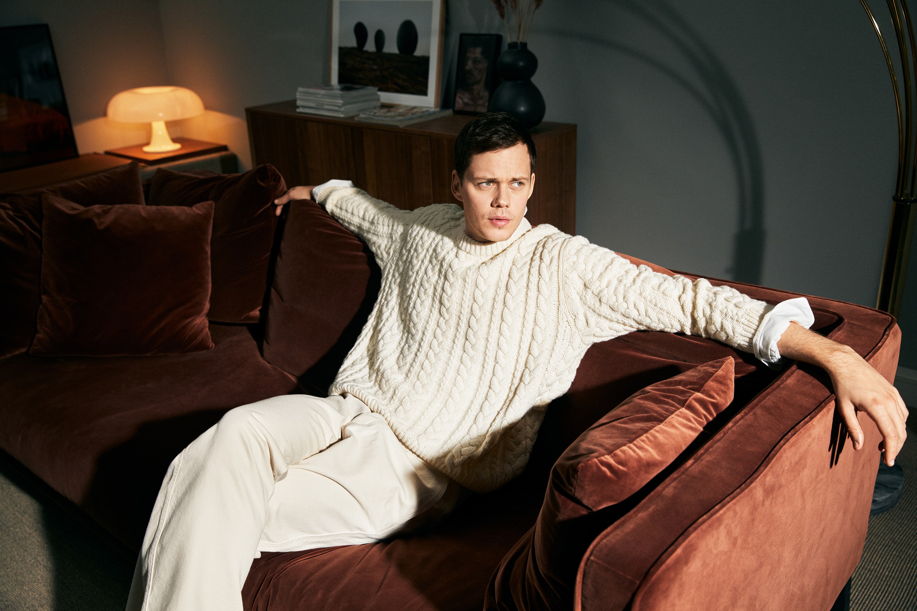Bill Skarsgård on a couch HD Wallpaper