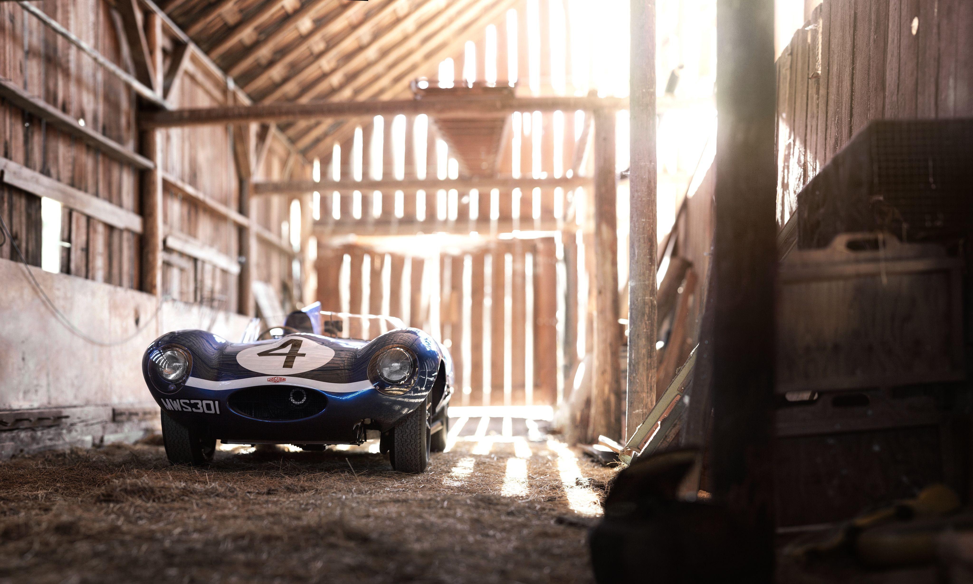 Blue Jaguar D-Type race car with number 4 in a barn HD Wallpaper