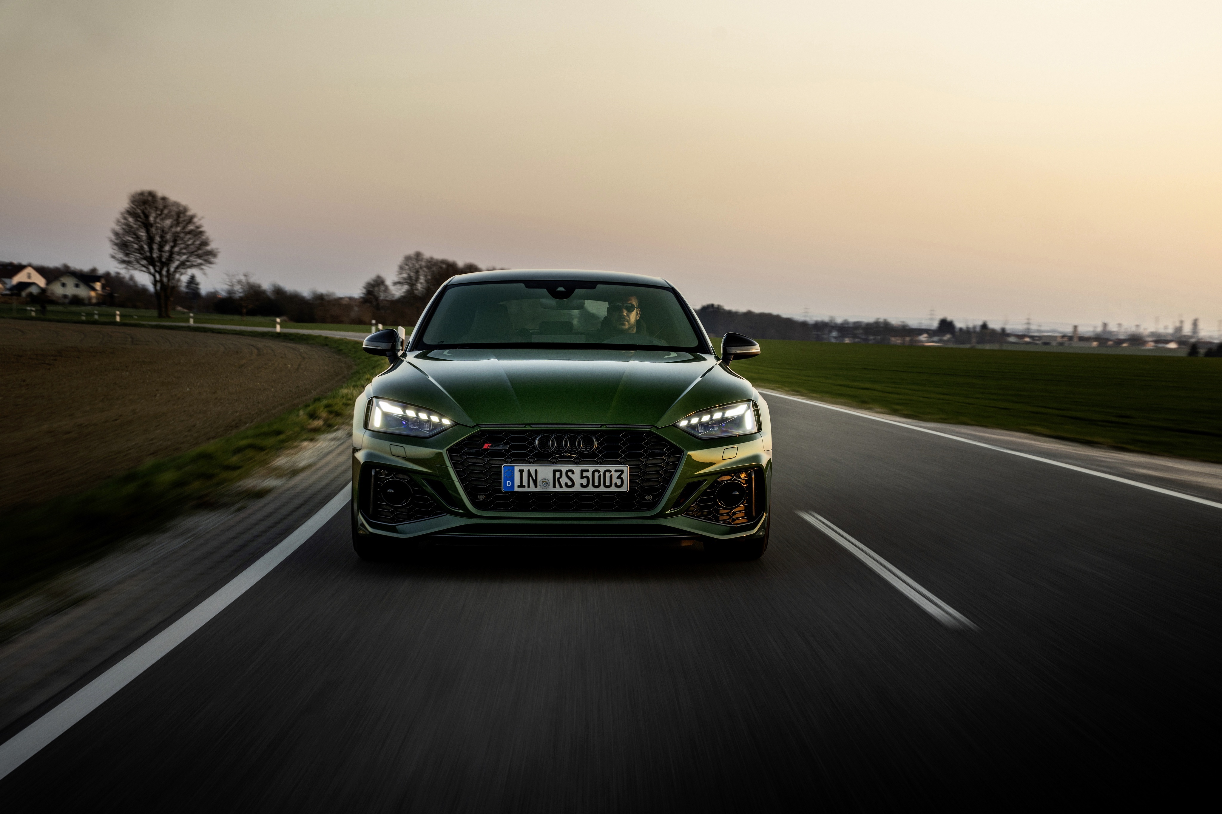 Green Audi RS5 driving on a road HD Wallpaper