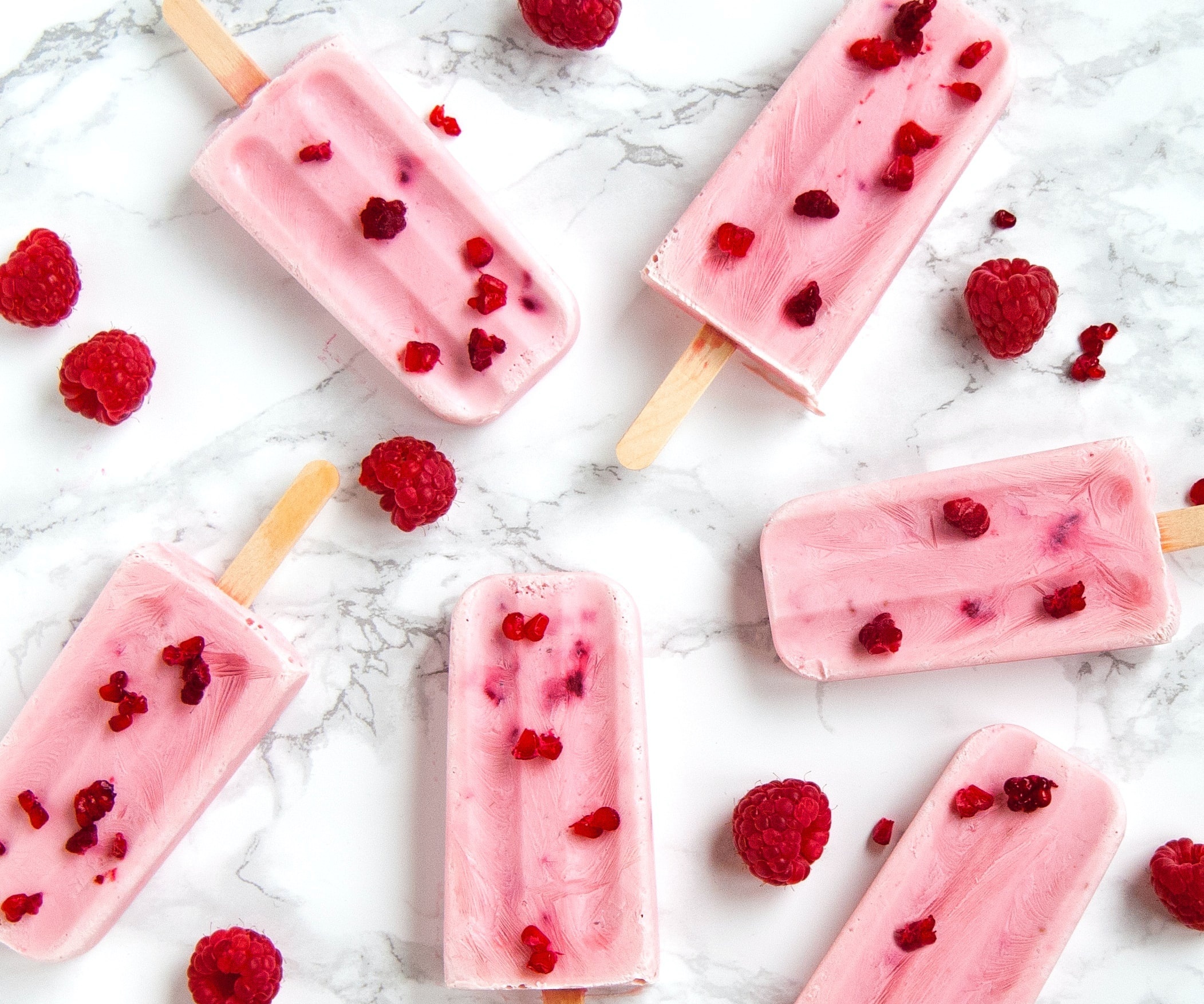 Raspberry popsicles with fresh raspberries on marble HD Wallpaper