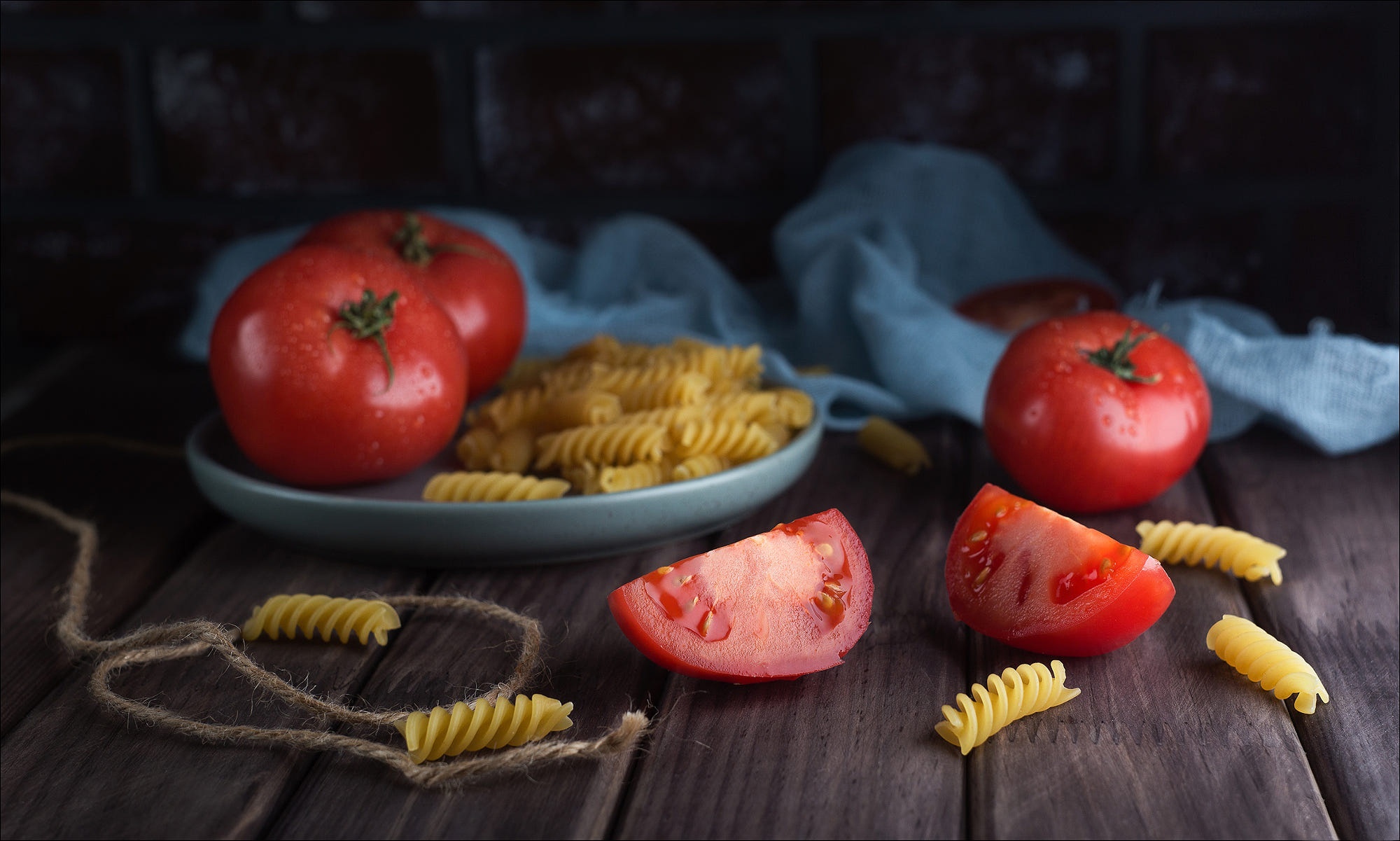 Tomatoes and pasta on a wooden table HD Wallpaper