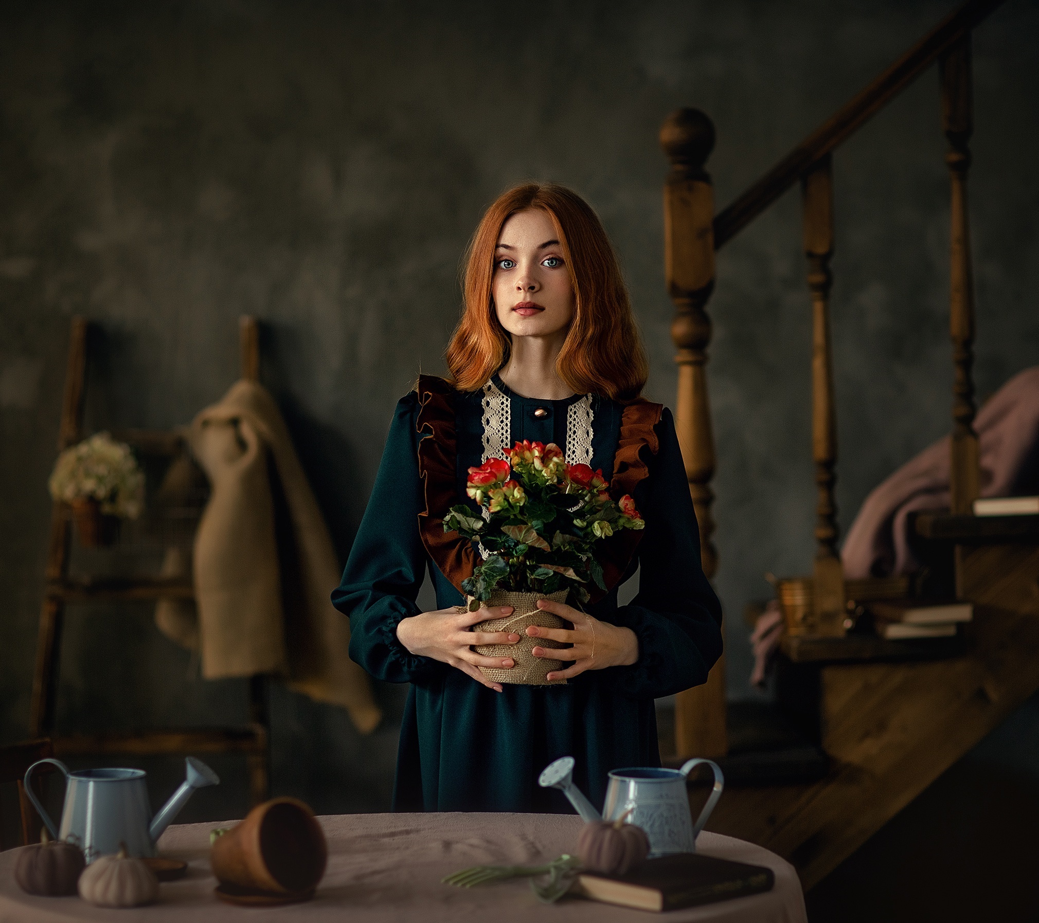 Young woman holding a potted plant indoors HD Wallpaper