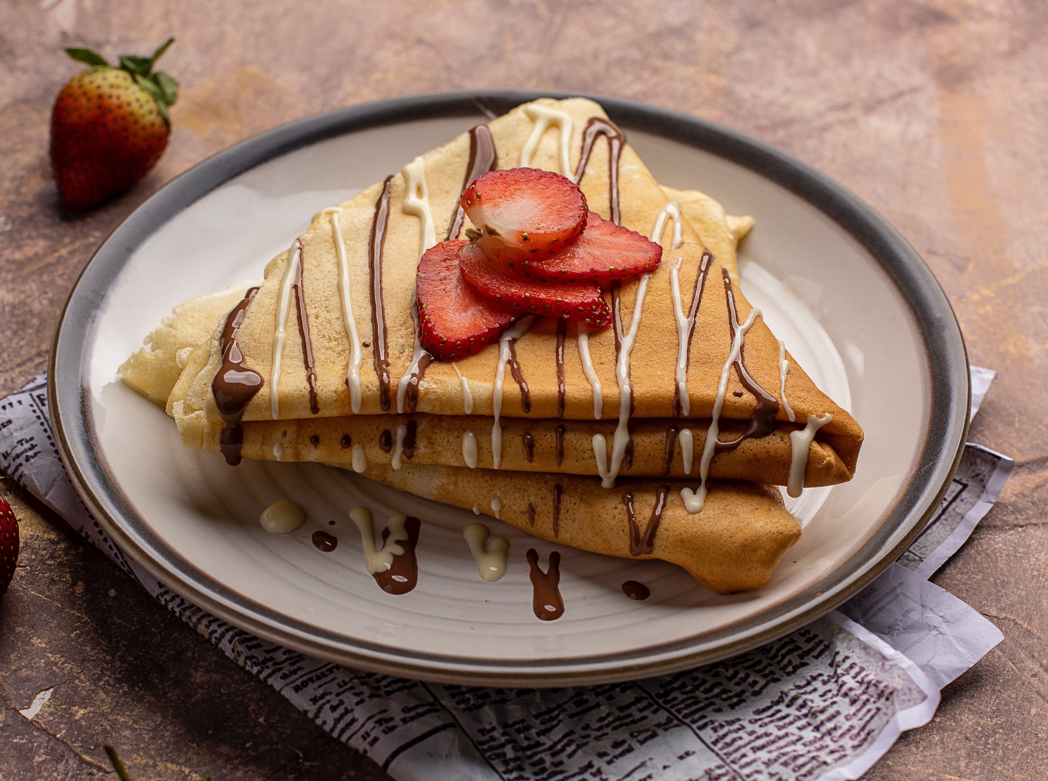 Crepes with chocolate and strawberry drizzle HD Wallpaper
