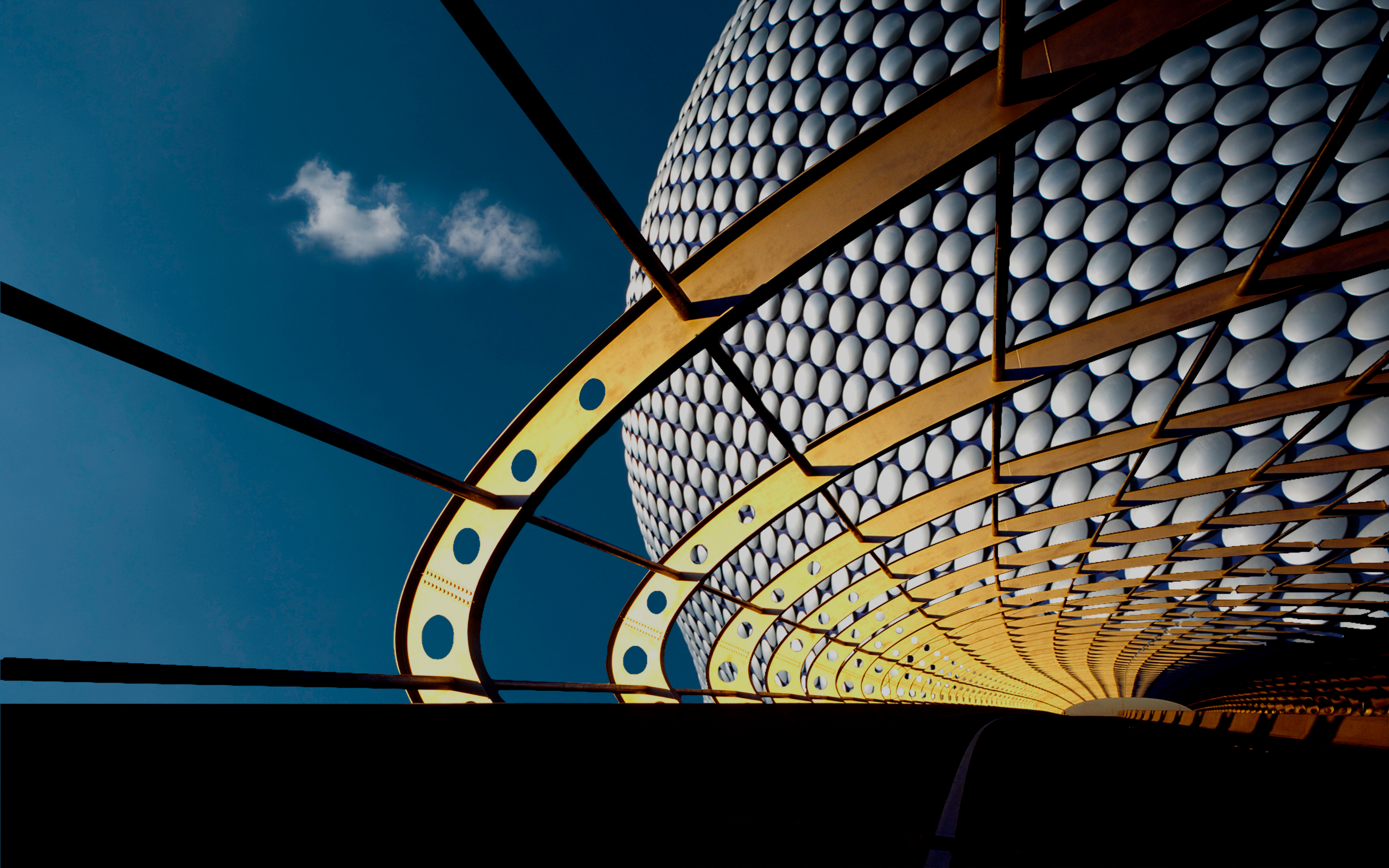 Modern architecture with metallic curves against blue sky HD Wallpaper