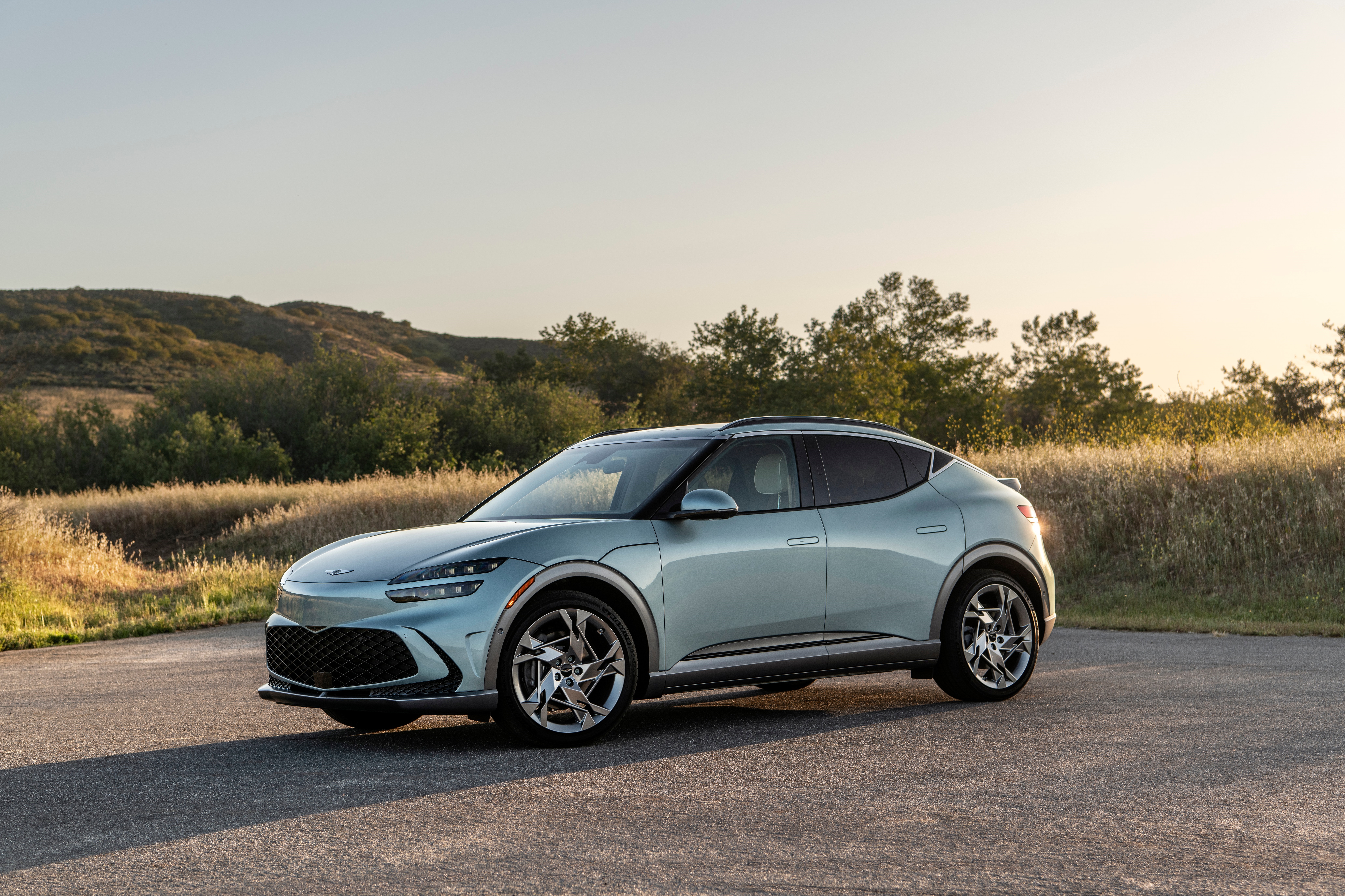 Genesis GV60 electric car on a road HD Wallpaper
