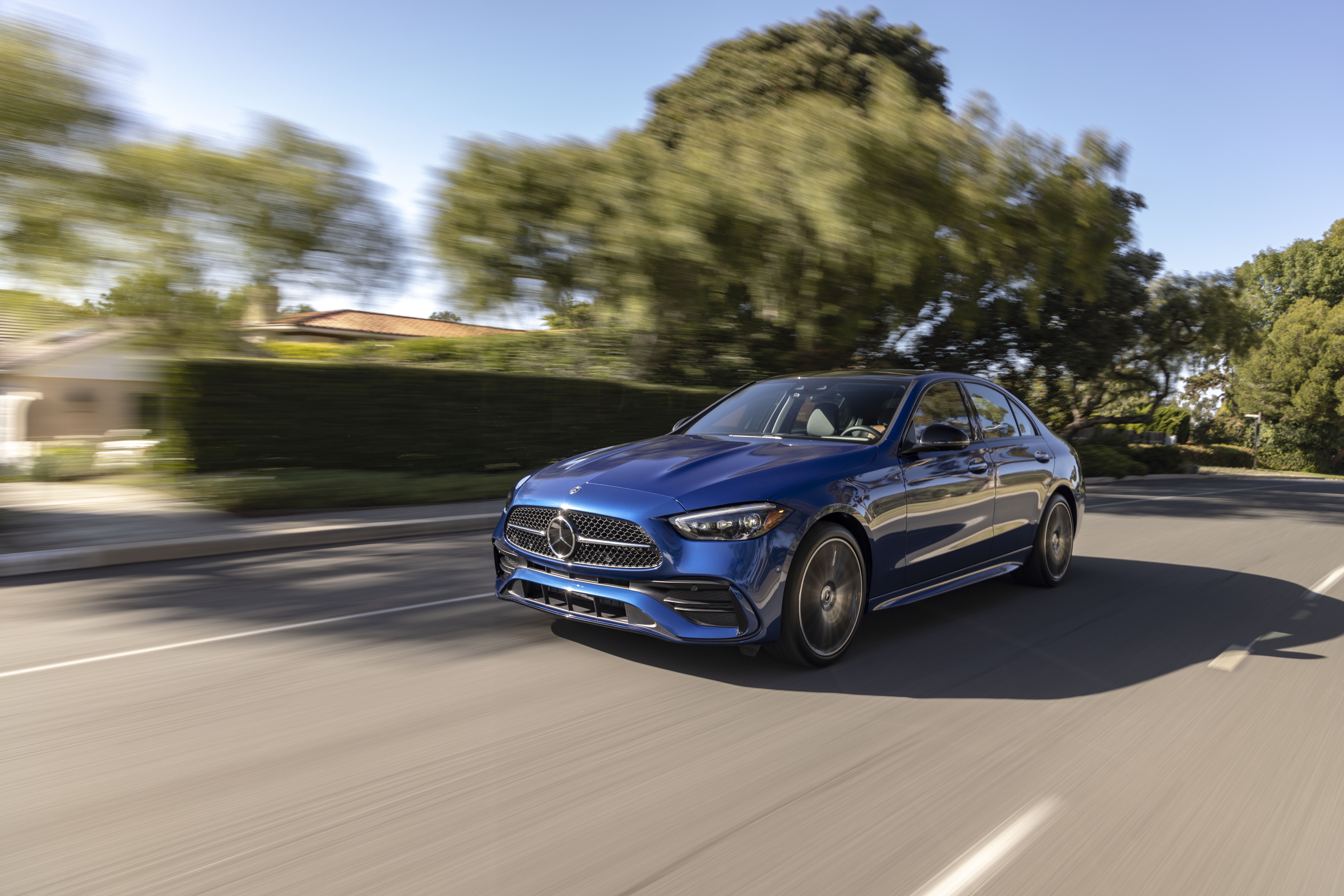 Blue Mercedes-Benz C 300 driving on a suburban street HD Wallpaper