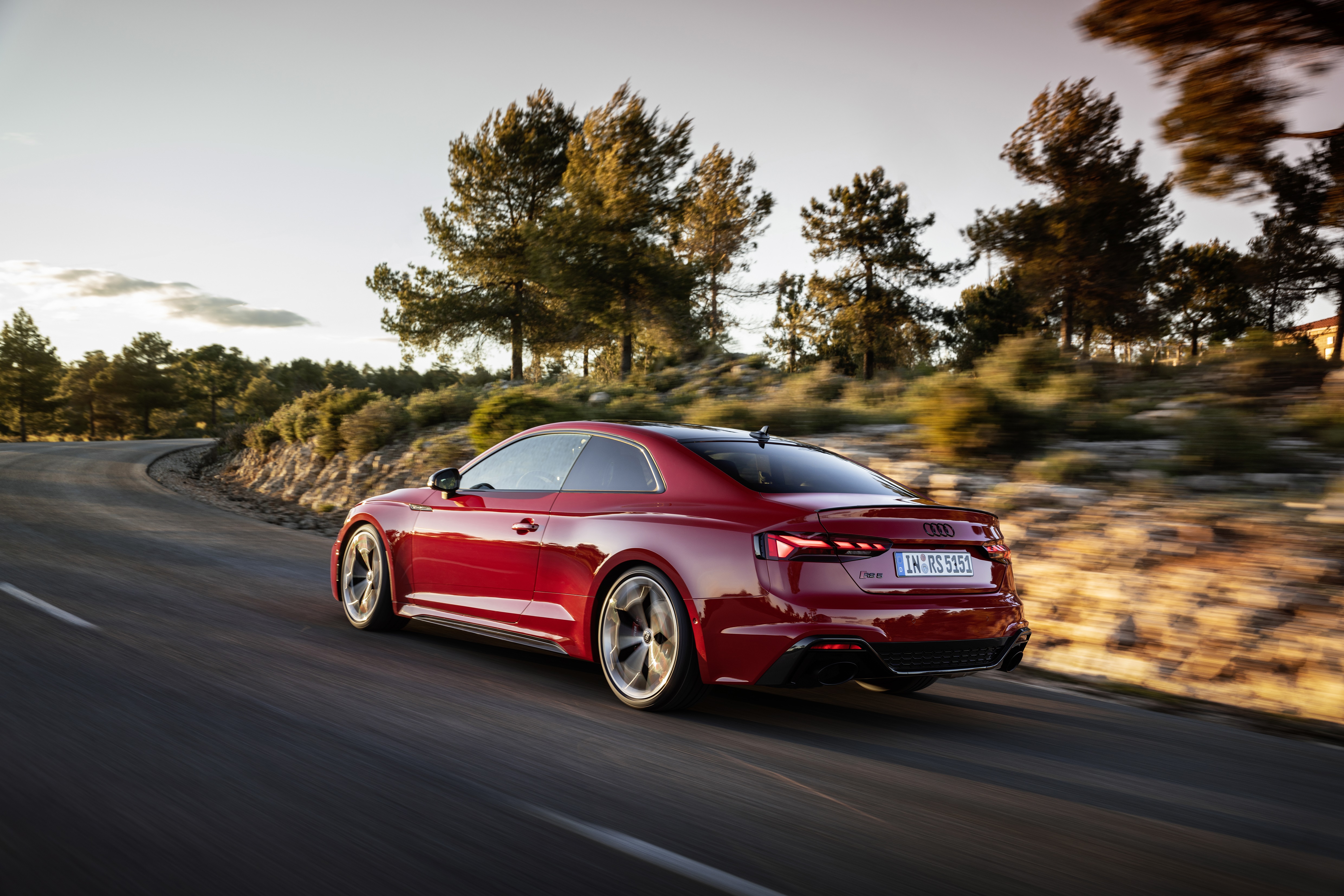 Red Audi RS5 driving on a winding road HD Wallpaper
