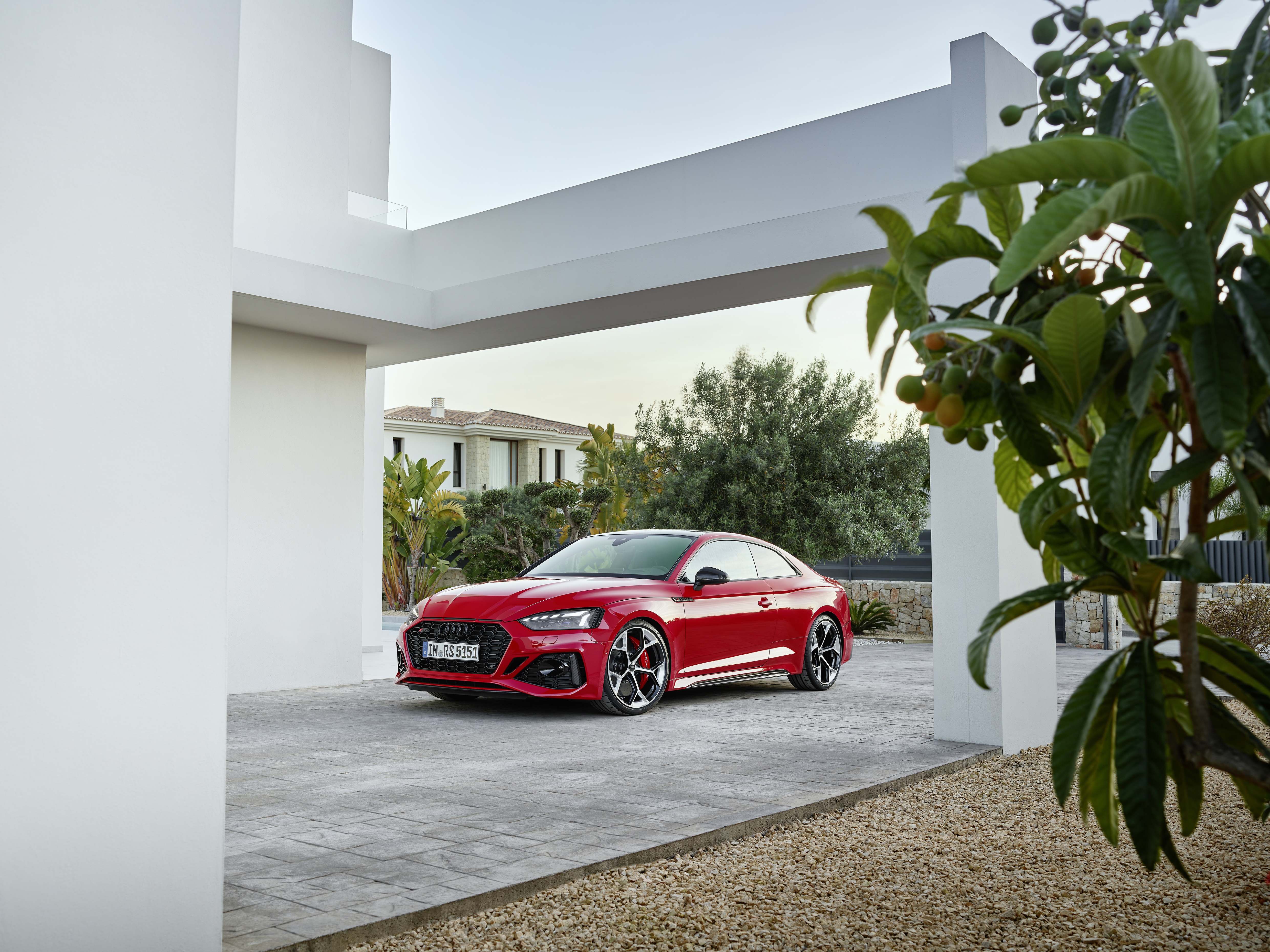 Red Audi RS5 4K parked in modern driveway HD Wallpaper