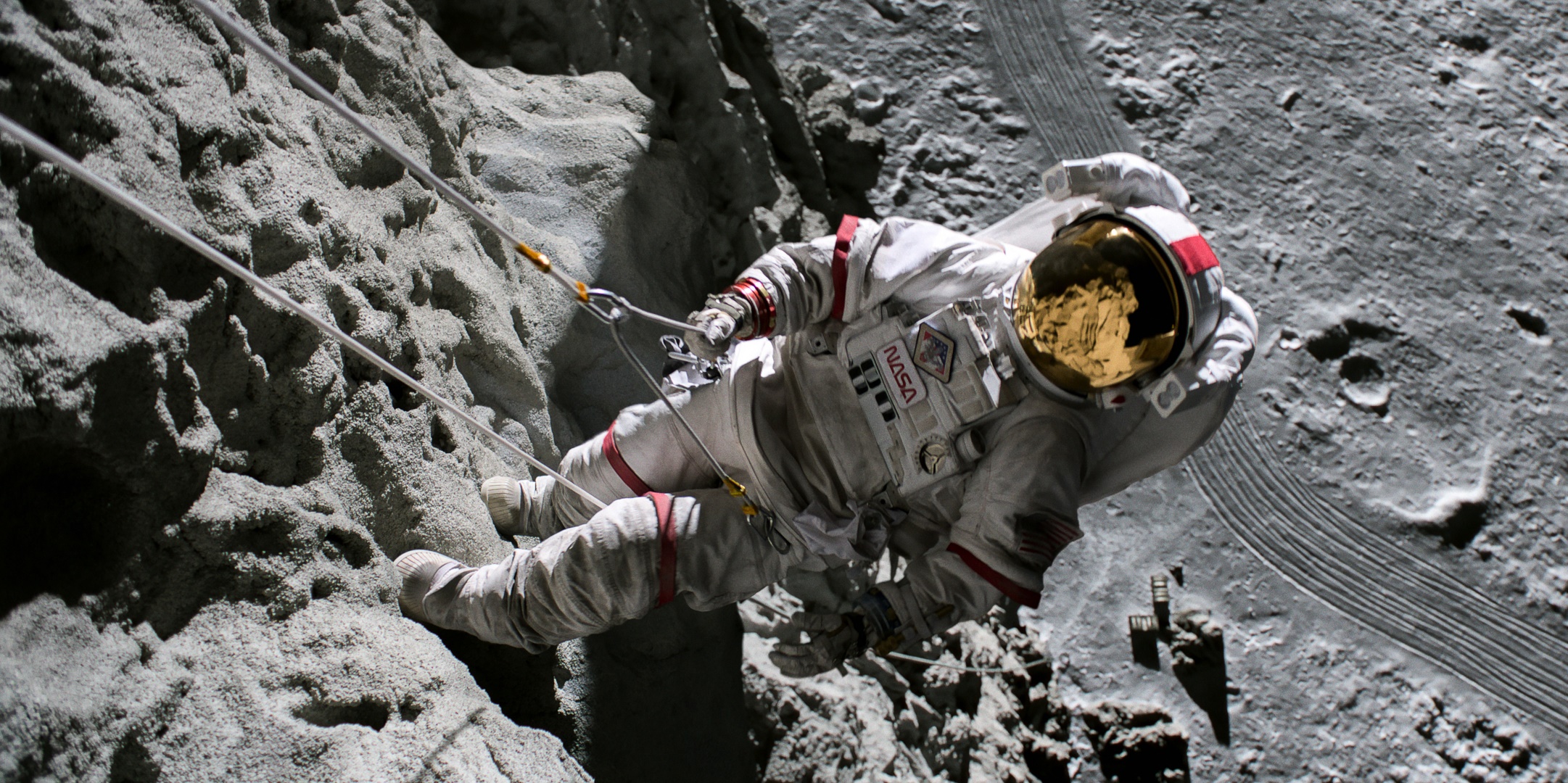 Astronaut rappelling down a rocky surface on the Moon HD Wallpaper