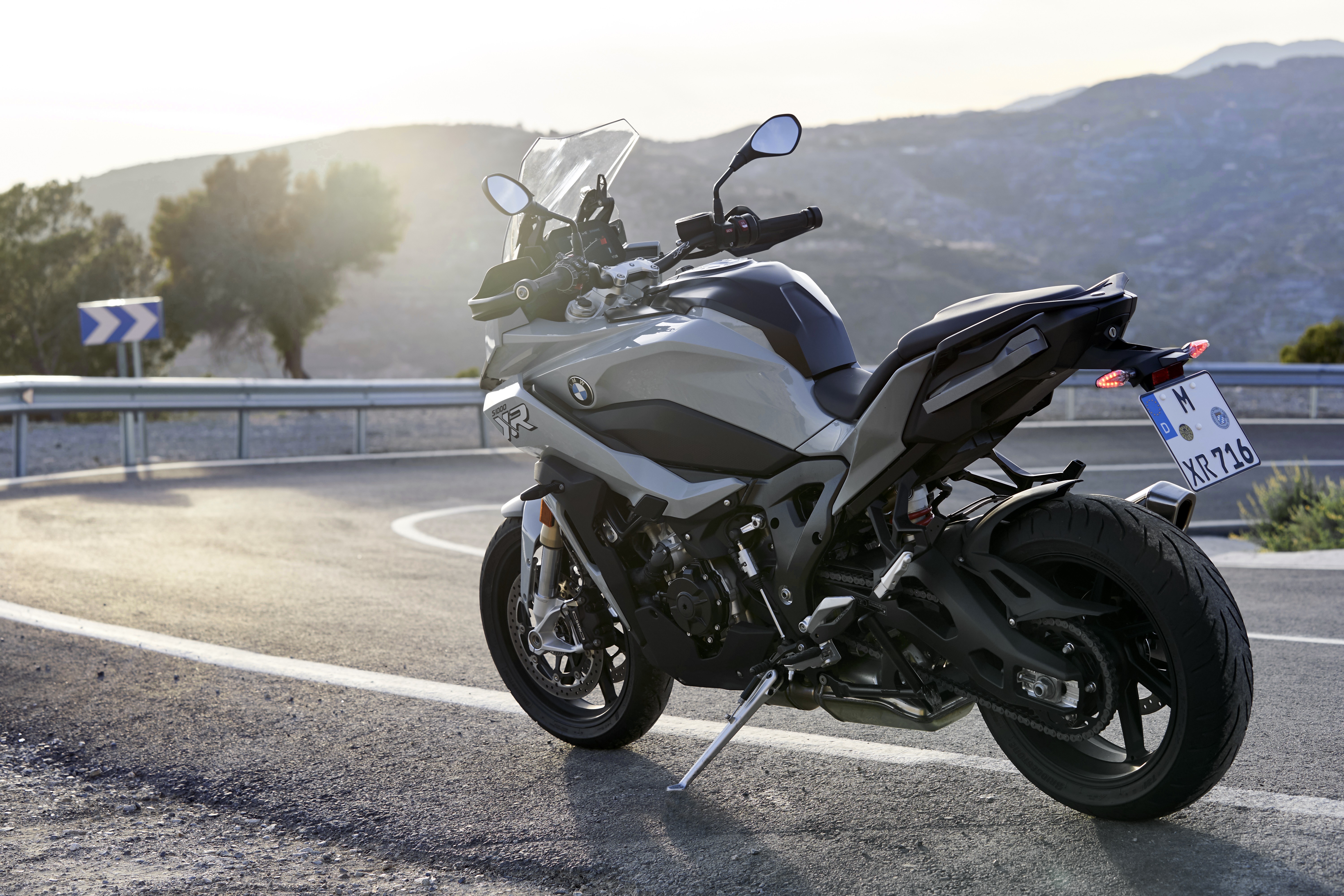 BMW S1000 motorcycle on a winding road HD Wallpaper