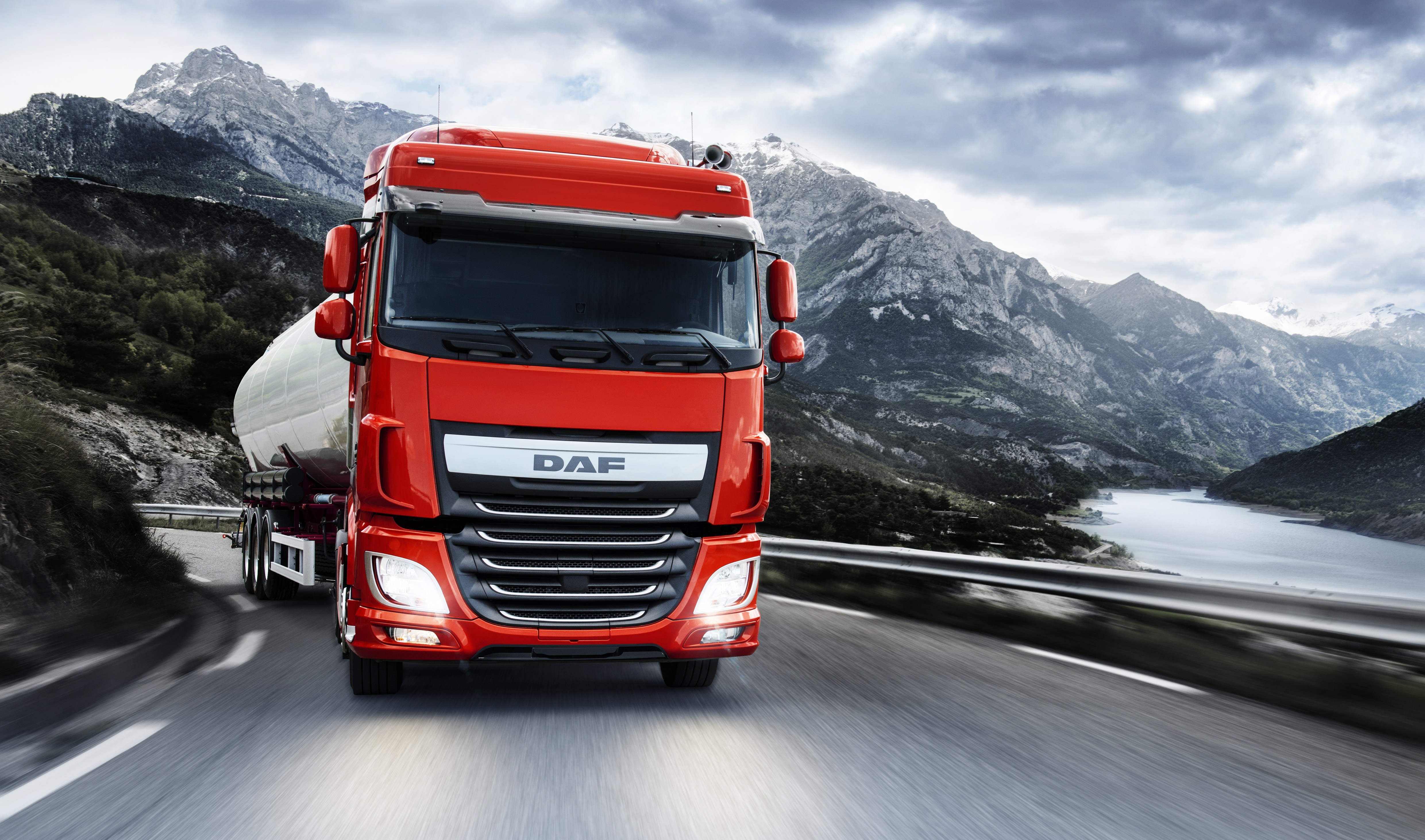 Red DAF XF FT truck driving on a mountain road HD Wallpaper