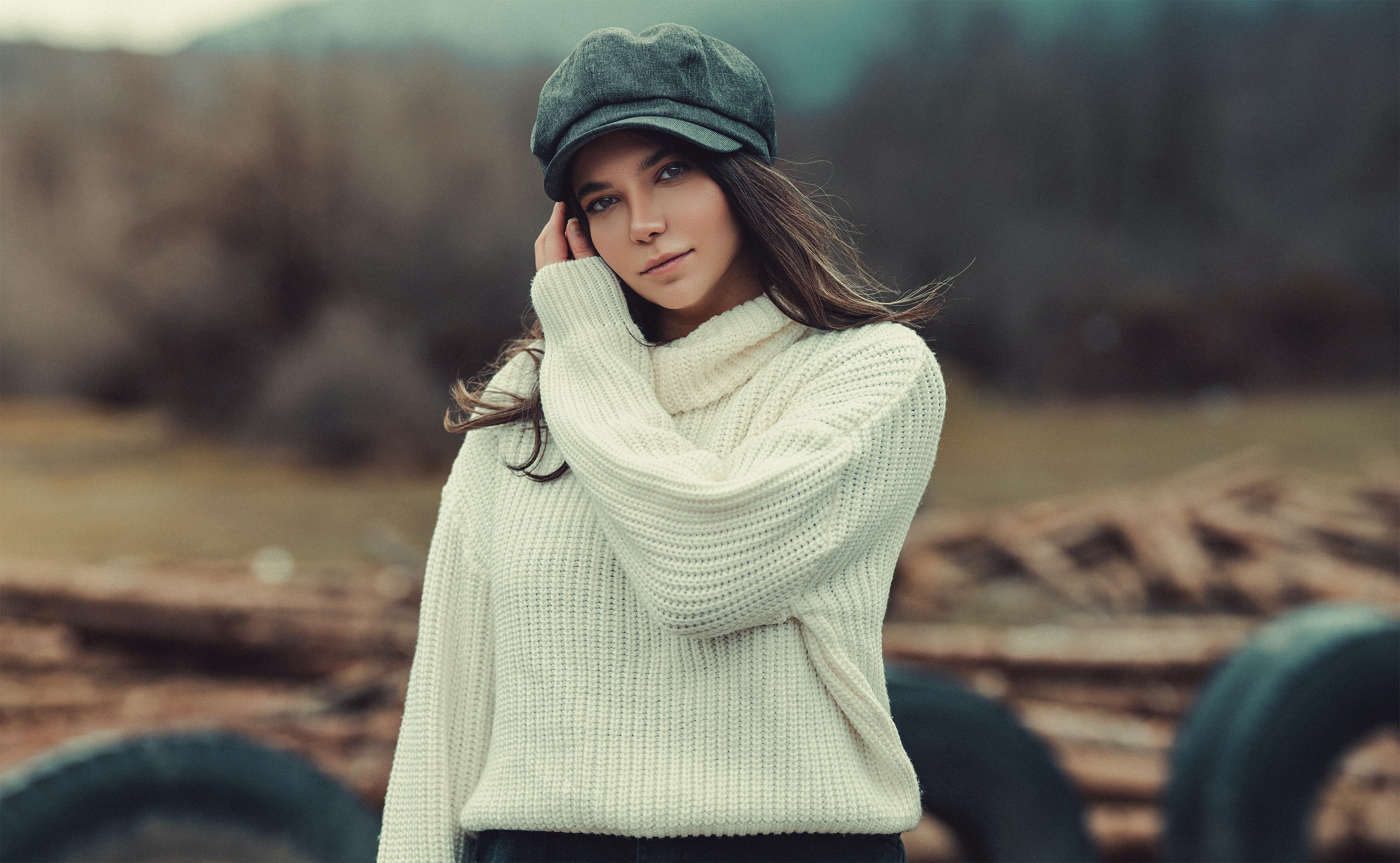 Woman wearing a sweater and cap outdoors HD Wallpaper