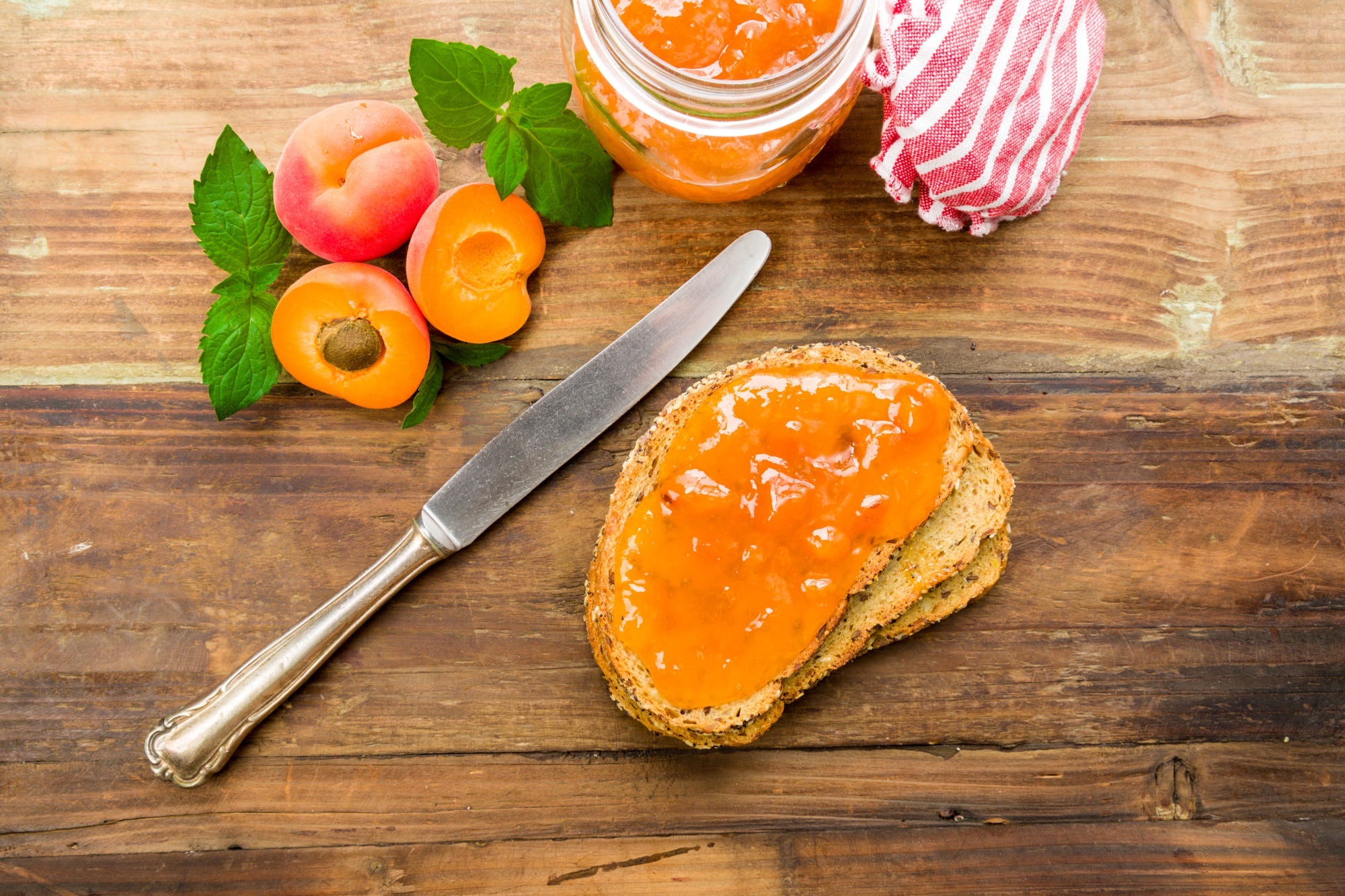 Apricots and jam on a wooden table HD Wallpaper