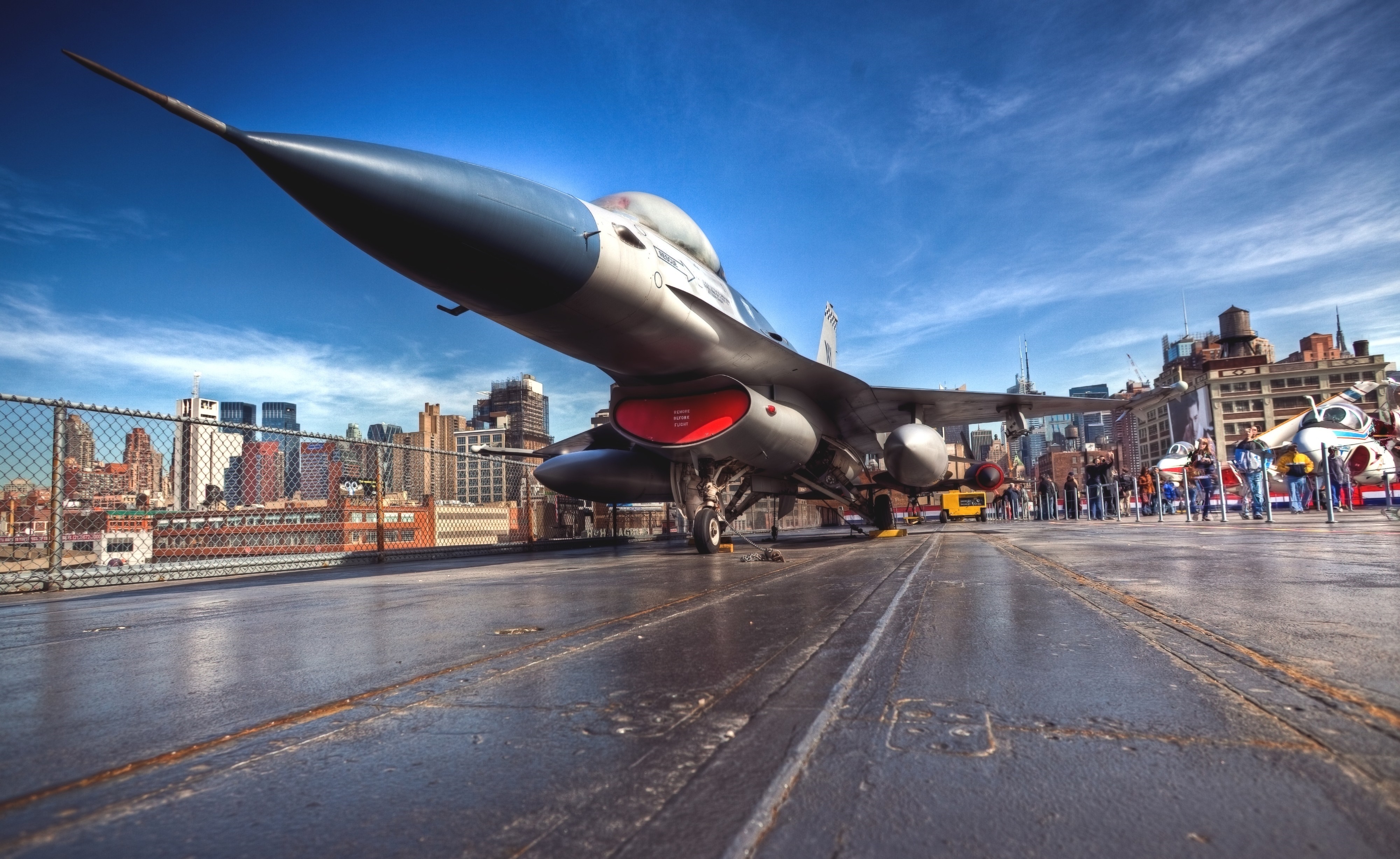 Fighter Jet on Aircraft Carrier with Cityscape HD Wallpaper