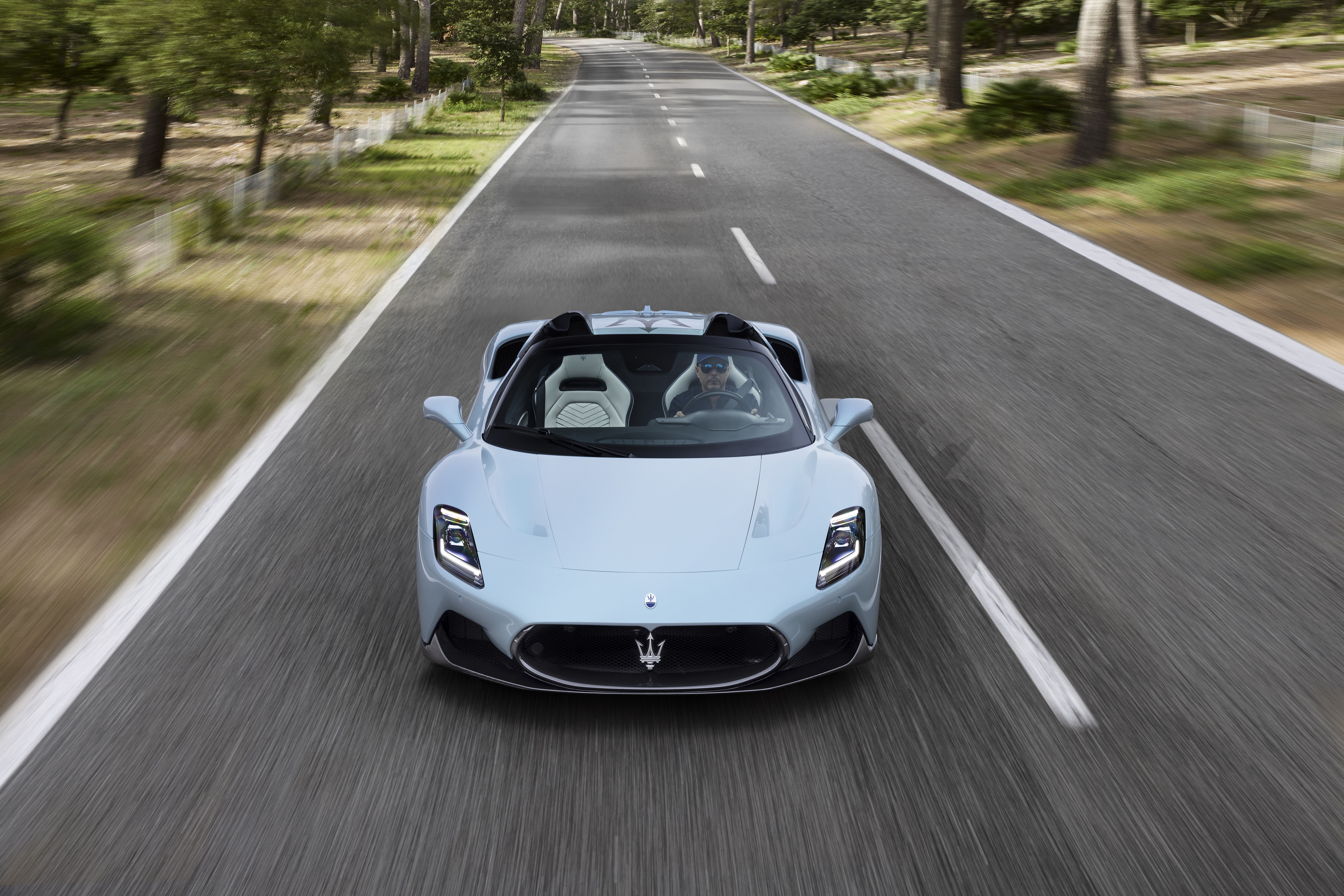 Maserati MC20 Cielo driving on a road HD Wallpaper