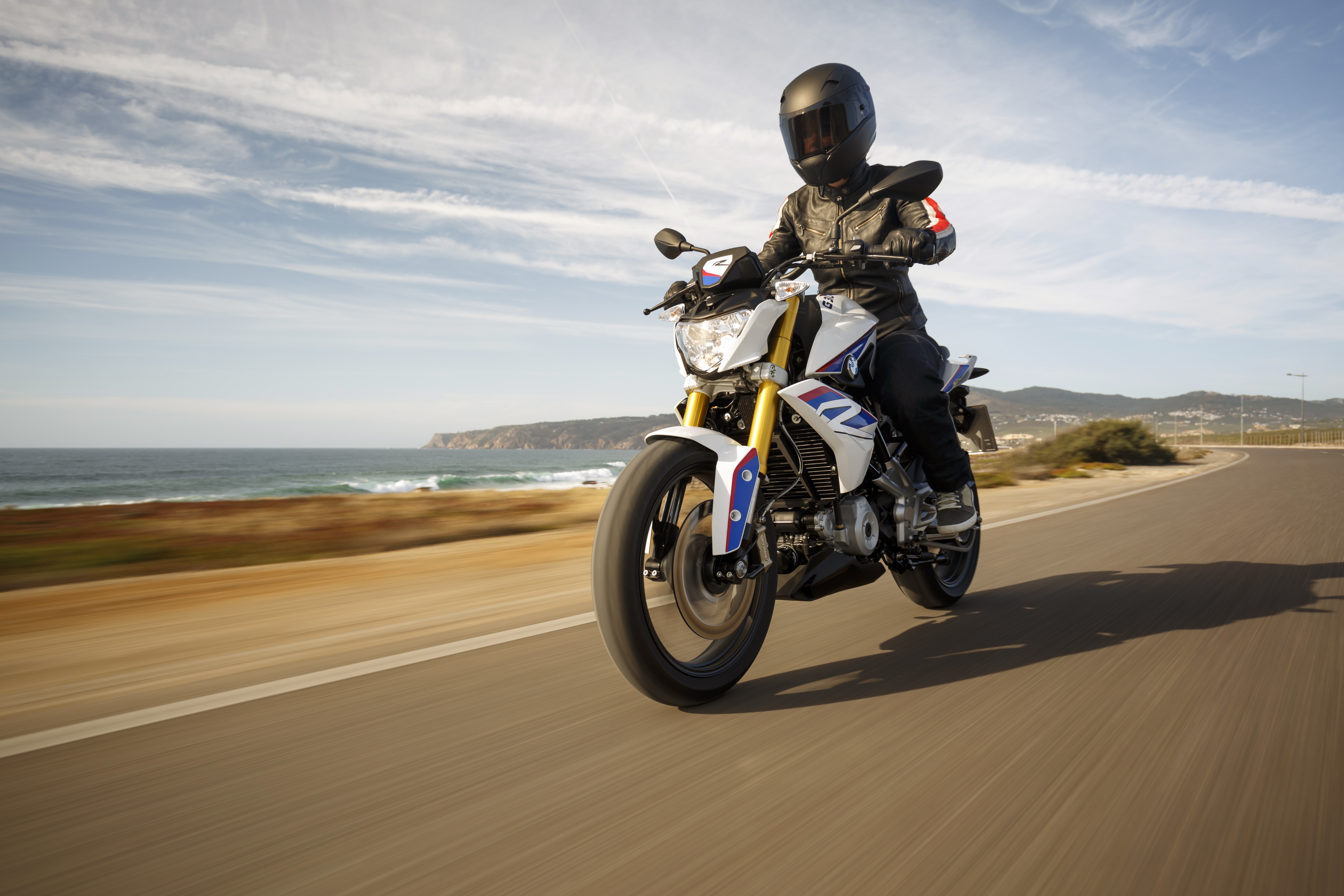 BMW G310R motorcycle on coastal road 4K HD Wallpaper